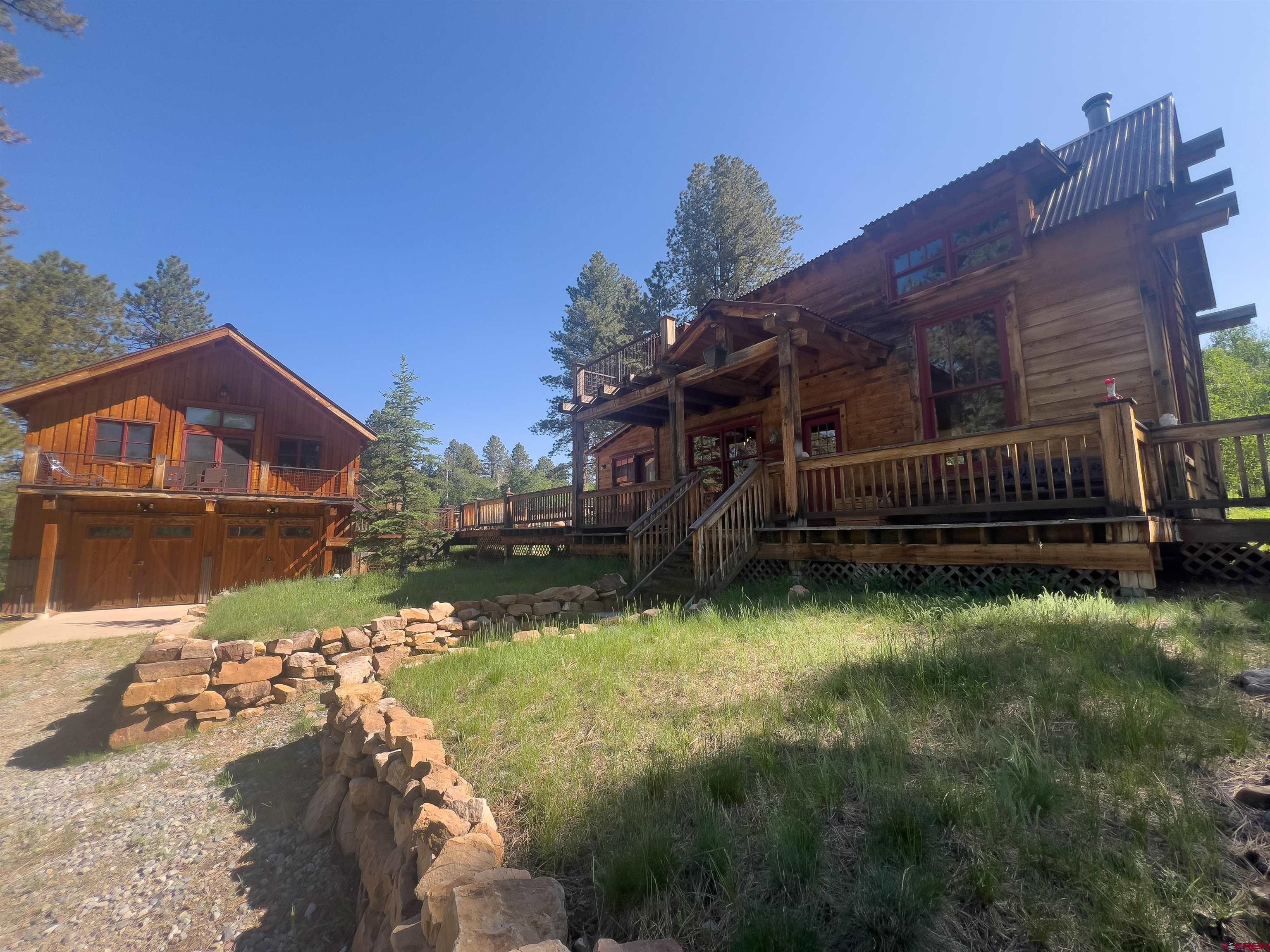 Congratulations. You've officially found the cutest Colorado cabin that Pinterest boards dream about. Say hello to Forrest Cabin—your cozy hideout complete with solar panels, heated floors, and more decks than friends you've kept in touch with since college. Yes. Yes. Your overly romantic, mountain-living fantasy just face-planted into reality. Main House Highlights: 2 bedrooms, 2 full baths, and a loft space that screams, ''You could do yoga here...but you won't.'' White oak floors so pretty you'll seriously consider enforcing a no-shoes rule for the first week. In-floor heat—because nothing says ''I've made it'' like warm toes in January. Vaulted ceilings and exposed beams that shout rustic luxury, while you quietly Google how to clean cobwebs 15 feet in the air..  Huge windows that make you feel like you're starring in a Nature Channel documentary, except you're the awkward human in flannel. Multiple deck spaces ,in the shade or sun, front or side, perfect for relaxing with the soothing soundtrack of rustling Aspen leaves, birdsong, and buzzing hummingbirds.  The Apartment (aka The "You're Welcome, Relatives" Suite) Lofted sleeping area, full bath, and a complete kitchen ideal for guests or the in-laws who love you but don't want to hear you snore. Connected by deck to the main house for ease and privacy. Perfect for visitors, adult children, or that friend who "just needs a few days to reset and find themselves."  Off-Grid Living, Seamlessly Integrated: Expansive solar system because you're rugged, but not candlelight-dinner-every-night rugged. Well water so clean it might just judge your city tap. Septic system that handles your... business, discreetly. Backup propane generator because nature is cool until it isn't. Heated garage with power for your toys, tools, or midlife crisis project.  Bonus Round: Polaris side-by-side with wheels and tracks basically the mullet of off-road vehicles. Partially furnished, which means less IKEA assembly for you Plus, the pond in the yard? It's not just a pond it's your new flat- screen, 24/7 wildlife reality show. Deer, birds, it's all here, no subscription required.  Location, Location, Location: 30 mins to Telluride where you can ski, people-watch, or pretend you're not checking Zillow on the gondola. 20 mins to Ridgway for small-town charm and likely a guy named Walt who sells organic honey out of a truck. 20 mins to Orvis Hot Springs aka the adult soup you didn't know you needed. 30 mins to Ridgway Reservoir if you're feeling sporty.  Whether you're here for peace, adventure, or just a really solid nap, Forrest Cabin has you covered. Nature's calling and this time, it's not about the bathroom.