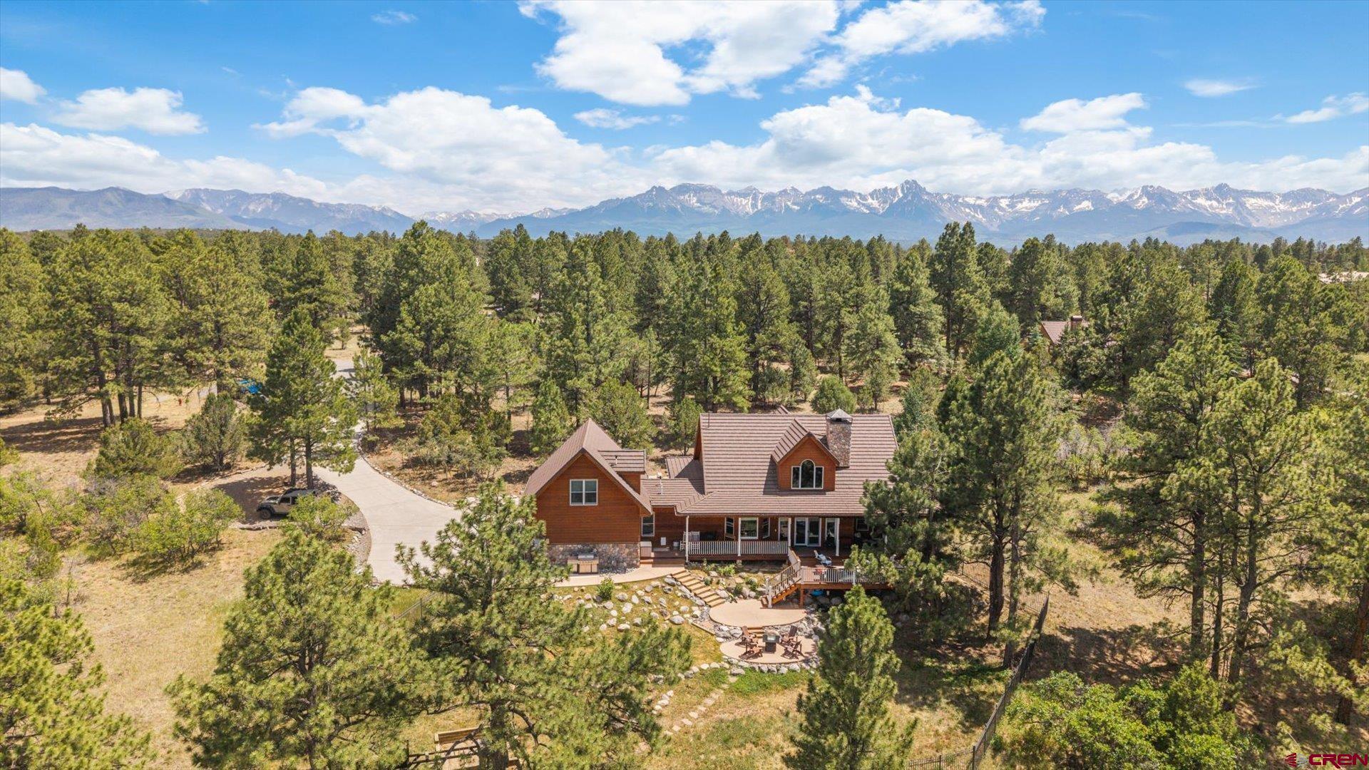 Situated at the end of a serene cul-de-sac within the esteemed Divide Ranch Golf Course, this exceptional 4-bedroom, 3.5-bathroom residence artfully combines privacy, comfort, and sophistication. Adjacent to the Greenbelt, with a great view of the 8th hole, this property not only offers seclusion but also benefits from minimal traffic.  Upon entering, you are greeted by expansive, light-filled living areas that are perfect for entertaining guests or enjoying daily relaxation. The gourmet kitchen, designed for social gatherings, flows seamlessly into a meticulously crafted outdoor living space, ideal for savoring morning coffee or hosting evening events beneath the stars. The main-level primary suite features a garden tub for a soothing soak, complemented by a steam shower for unwinding after a long day. A unique attribute of this home is the separate bonus room, which includes its own private bathroom, presenting a multitude of possibilities. This versatile space could serve as a craft or hobby studio, a dedicated home office, or be easily transformed into a multi-generational living suite. Whether you are an avid golfer, a nature enthusiast, or simply in search of a peaceful retreat, this property epitomizes the lifestyle you have always envisioned.