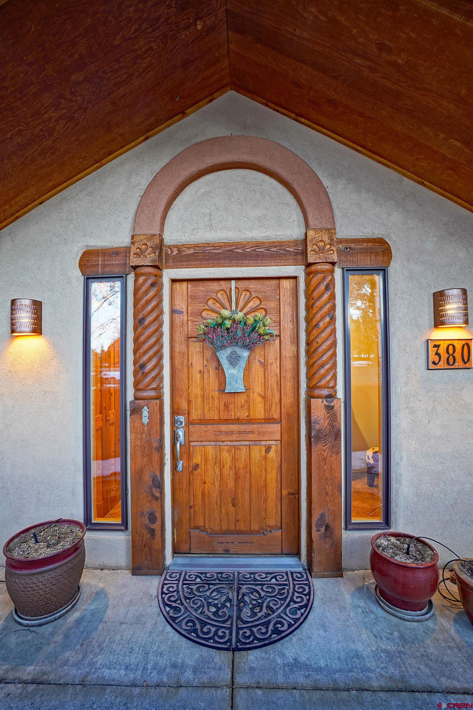 A Colorado Mountain modern luxury masterpiece in Divide Ranch, Ridgway, Colorado, featuring some of the best golfing, hiking, biking and skiing, in the San Juan Mountains.This exceptionally well Built home all on a single-level has been meticulously remodeled by it's current owners. Saltillo tile floors, handcrafted Santa Fe doors, and custom cabinetry are accent by high-grade granite countertops with designer lighting. Fully updated bathrooms. A renovated dream gourmet kitchen with new kitchen appliances. This fine home is adjacent to Divide Ranch championship golf course though the home is shielded by a forest of Ponderosa trees. This 2,600 square feet home has nearly 800 square feet of outdoor deck and recreational space with a very nice hot tub.  An enclosed courtyard entrance sets a welcoming scene, leading into a spectacular living space with a vaulted Pine tongue-and-groove ceilings and exposed beams. The south-facing living room features a beautiful kiva-style fireplace with builtin wood storage. The primary suite is a private sanctuary with a fireplace, spa-like bath and soaking tub, an oversized walk-in shower, and a spacious walk-in closet. with direct access onto an expansive rear deck and patio. Easy year-round access, a newly resurfaced paved circular driveway, and a heated 2 car garage. Just a short drive from Ridgway’s vibrant downtown, and Telluride’s world-class skiing, this is the ultimate home base for adventure and relaxation.