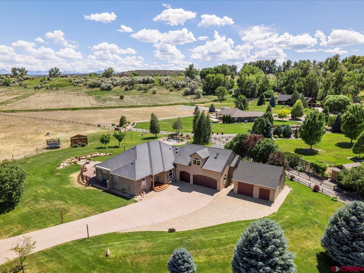Refined Mountain Living on 4+ Acres – Style, Space & Unmatched Craftsmanship  Welcome to 63200 Percheron Court, where modern luxury meets quiet Colorado living. Tucked away on a private cul-de-sac just minutes from town, this meticulously designed residence sits on 1.37 beautifully landscaped acres—plus an included 3-acre adjoining parcel, offering a rare 4.37-acre opportunity for future expansion, privacy, or investment.  Step inside to over 2,900 square feet of thoughtfully curated living space, where comfort, style, and function blend seamlessly. The heart of the home—the chef’s kitchen—has been fully remodeled with Wolf and Sub-Zero appliances, Brazilian granite countertops, steam and conventional ovens, a pot filler, and an instant boiling/filtered water system. Whether you're cooking for two or hosting a crowd, this space delivers gourmet-level performance with timeless style.  Unwind in the expansive bonus room above the garage, featuring a custom bar, skylights with remote-controlled shades and ventilation, and direct roof access—perfect for star-gazing or summer evenings above it all.  Built with comfort and efficiency in mind, the home features in-floor radiant heating, central HVAC, individual thermostats in every room, solar-powered attic fans, and a partially heated driveway and patio to keep winter worry-free. Additional amenities include a central vacuum, on-demand hot water, water softener, radon mitigation system, and a state-of-the-art roof ice melt system. Outside, enjoy serene moments by your private backyard pond with dual waterfalls, or relax under any of the five automatic awnings that provide shade at the touch of a button. The 33’ x 33’ detached shed offers excellent space for a workshop, RV/boat storage, or future studio.  The oversized 3-car garage features epoxy flooring and a secure fireproof vault with an alarm system—ideal for storing valuables or documents. A full home security system adds even more peace of mind. Don’t wait, call your favorite agent for a showing today!