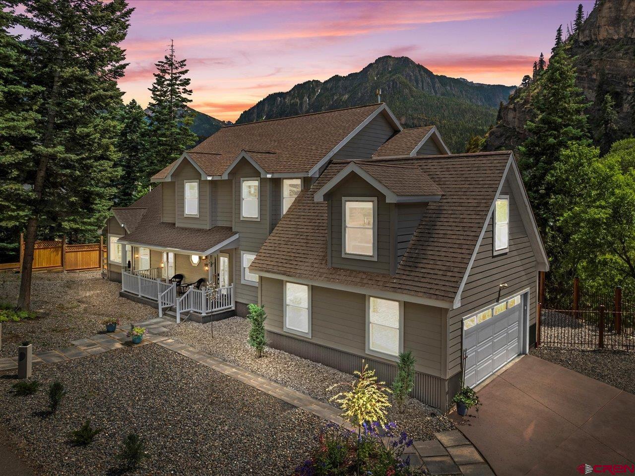 Welcome to Ouray Vista! One of Ouray, CO most loved and sought after neighborhoods. This beautiful air conditioned home hosts 4 bedrooms, 5 bathrooms, and a bonus room above the garage with a three piece bath. As you enter the home you are greeted by huge windows looking out into Ouray and the mountains beyond, filling the room with lots of natural light, making your great room very inviting and cozy. The kitchen is a dream with granite countertops, hickory cabinets and a large pantry. Two bedrooms are located off the living room. One is a large mother-in-law suite with a private entrance, bedroom, sitting or flex room and elegant five piece bathroom with a walk in closet.  Upstairs has two bedrooms. The primary suite is very spacious with dual closets, a light and bright dressing room area and gorgeous five piece bathroom.  The second bedroom upstairs, is also light and bright with an ensuite bathroom! The laundry room is located off the garage entrance as well as a three quarter bathroom.  This house has great curb appeal with attractive landscaping and welcoming front porch!  The backyard has recently been completely redone. The current sellers built a retaining wall and added a privacy fence creating a private and enticing backyard area. The garage door was replaced just a few months ago.  There is an RV hookup and dump on the south side of the house.   This house is ready for your family to move in!  Sit in the hot tub and enjoy the breath taking views surrounding you.  This is what we call a little piece of heaven.  Within walking distance to everything downtown!