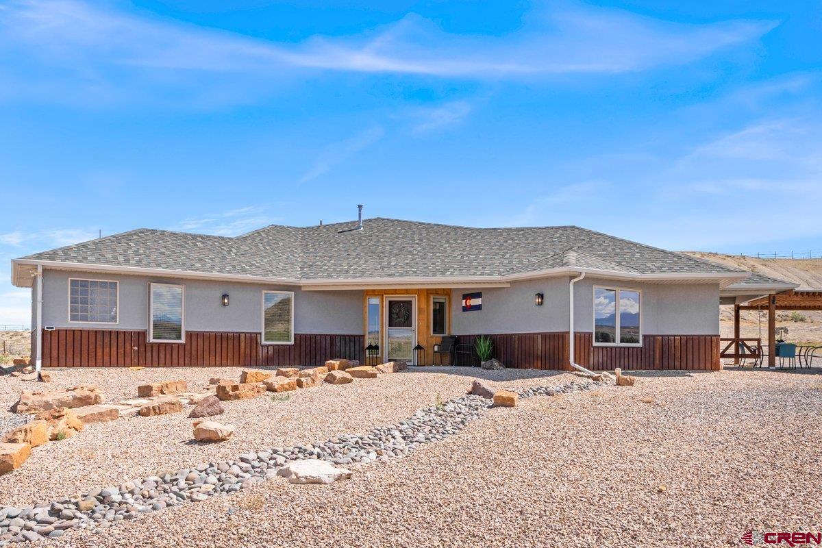 A Rare Find for Serene Country Living in Southeast Montrose  Welcome to a lifestyle of ease, comfort, and quiet beauty in one of Montrose’s most sought-after and rarely available neighborhoods. This charming 2-bedroom, 2-bathroom home on 3.2 acres offers the perfect balance of privacy and convenience—ideal for those ready to slow down and savor the best of Colorado living.  From the moment you arrive, you’ll feel the tranquility of this special property. Nestled in a peaceful, established community with lovely views of the Cimarron Mountains, this home is designed for low-maintenance living and high enjoyment. With polished concrete floors throughout and a well-appointed kitchen featuring granite countertops, everything is built to last—and built to be enjoyed.  The attached 2-car garage offers everyday convenience, while the custom-built, heated metal garage (24' x 43' x 15') with a 14' roll-up door is a dream for those with a love for RV travel, hobbies, or storing outdoor gear. Whether you're hitting the road for adventure or staying home to work on personal projects, this space offers room to grow.  Enjoy morning coffee or an evening glass of wine on the patio while watching deer wander through and the sky light up with sunset colors. The backyard is perfectly suited for quiet moments, casual gatherings, or barbecues with friends and family.  Inside, the primary bathroom features a soaking tub—perfect for relaxing after a scenic drive or a day exploring the nearby Black Canyon, Grand Mesa, or the trails of the San Juan Mountains. Montrose also offers excellent healthcare facilities, vibrant shops, and beloved local restaurants, along with fun community amenities like a family-friendly water park.  Whether you're looking to downsize, retire, or simply a quiet home base to return to between travels, this home checks all the boxes: peaceful, practical, and full of possibility.