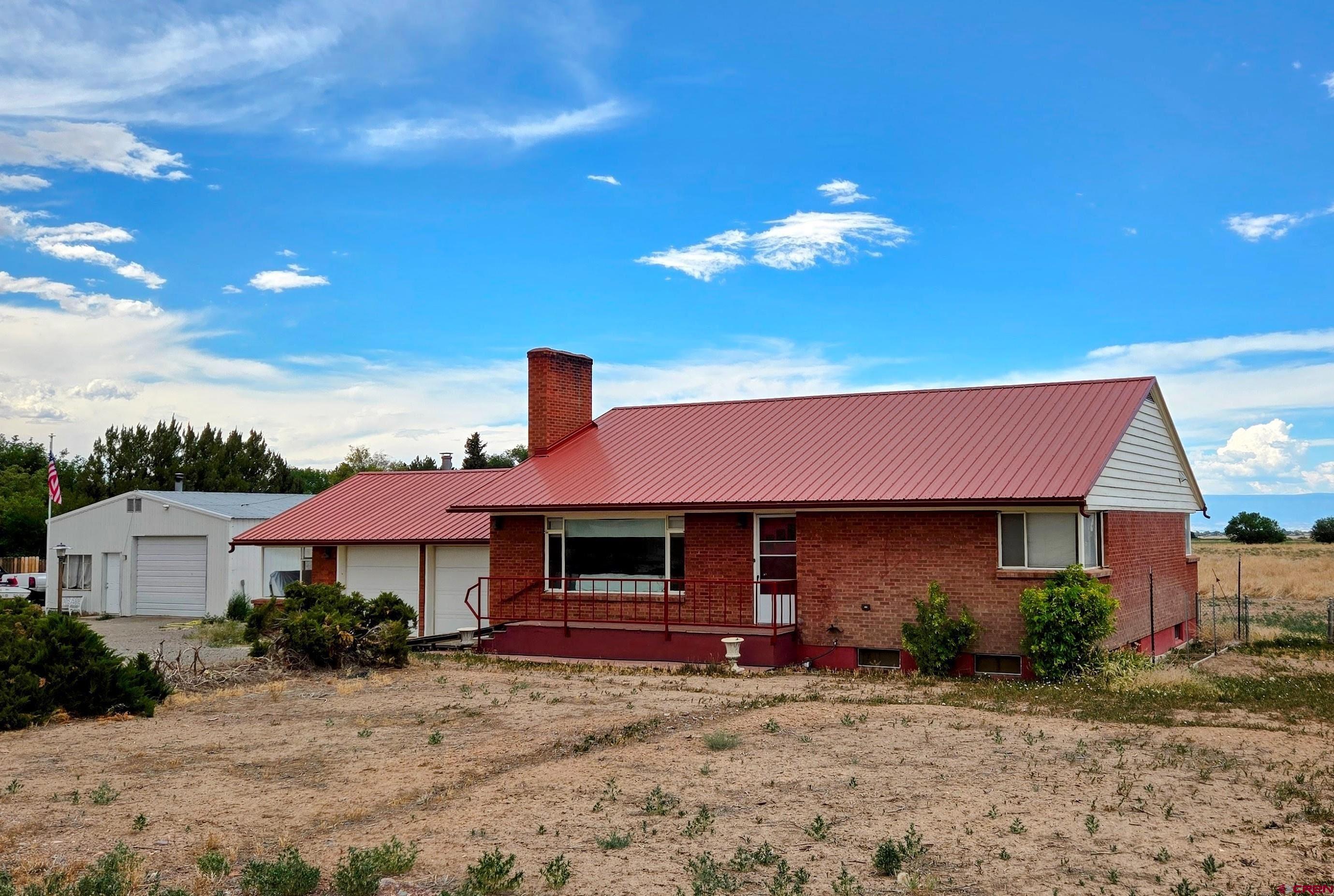 So much to offer at such a reasonable price: A duplex-styled home, a heated workshop, 12.9 acres of irrigated farmland, with a potential for subdivision on beautiful Spring Creek Mesa.  Direct views of the San Juan Mountains to the south.  The main level of the home has 2 bedrooms, a full bath, large living room and the kitchen with dining area.  All flooring except the kitchen is original hardwood. Below ground is a similar floorplan which was totally built-out in 2018 and now utilized as fully furnished rental unit.  Additionally, the basement has two stairway entrances; one from garage and the other out back.  Recent upgrades also include a new on-demand hot water boiler system, with side-arm tank, for heating and domestic.  Plus, all new electric service throughout.  The 15 X 30 ft shop has a slab floor, insulation, plus front and rear roll-ups.  The attached garage has room for 3 vehicles, includes a woodstove for heat and has an oil-change pit in the floor.  The back 11 acres has underground irrigation pipes has been successfully farmed up until last year.