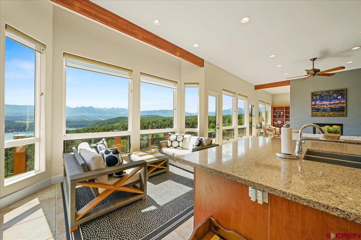 This stunning 4-bedroom, 4-bath mountain water view home offers 4,700 square feet of refined living space, perfectly positioned on a private cul-de-sac above Ridgway. Designed to capture the essence of the San Juan Mountains, the home showcases dramatic views of Mount Sneffels Range, the Ouray Valley, Cimarron Ridge, Storm Peak, and the sparkling blue waters of Ridgway Reservoir. Soaring ceilings and expansive windows fill the home with natural light, framing breathtaking panoramas from nearly every room. The spacious, open floor plan flows effortlessly to the oversized deck—ideal for outdoor entertaining or peaceful mornings immersed in mountain serenity. Crafted with warm, rustic finishes and high-end modern touches, the home also features a large three-car garage, generous storage, and thoughtful layout for comfort and privacy. Located minutes from Ridgway, yet tucked into a serene natural setting, this property is the perfect blend of luxury, nature, and Colorado lifestyle.