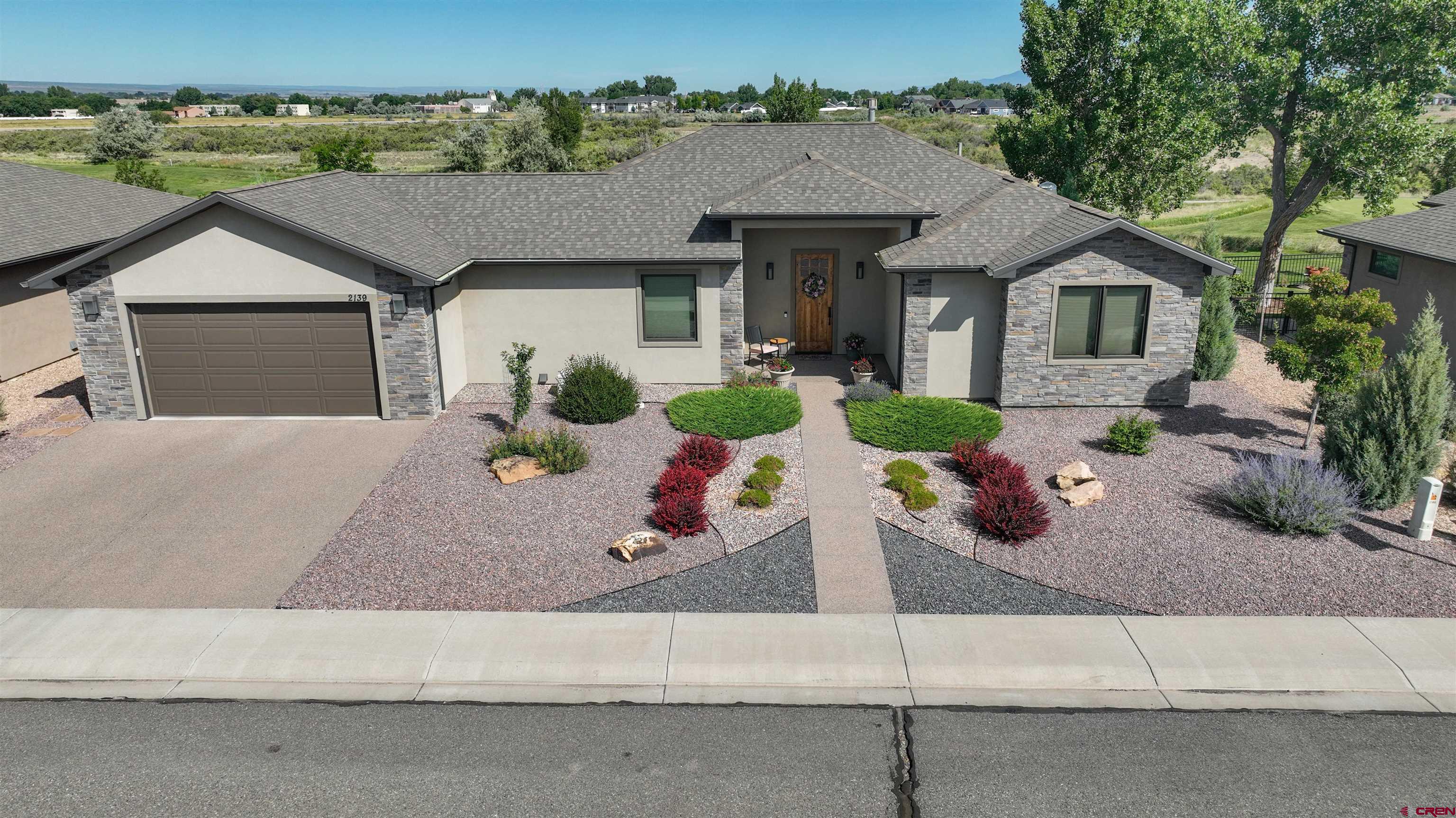 Come Home to One of the Finest Patio Homes in Montrose! This exquisite Signature Ridge at The Bridges home is a walk-in, walk-out location to the 12th tee box at The Bridges at Black Canyon Country Club—perfectly positioned just steps away from teeing off. This golf course home offers unparalleled access to one of Montrose’s premier courses—bringing the luxury of resort-style living right to your doorstep. Experience refined living in this premier golf community, along with the lock-and-leave convenience of an impeccably crafted, modern single-level home situated in one of Montrose’s most desirable neighborhoods. From the moment you step inside, you'll appreciate the effortless elegance and turnkey convenience—every detail has been thoughtfully curated so you can move in and immediately enjoy. A perfect harmony of impeccable design and craftsmanship, this 3-bedroom (one non-conforming), 2-bath residence offers an elevated living experience for the discerning homeowner. The inviting open-concept layout is complemented by expansive windows that face the tee box and bathe the interiors in natural light, highlighting clean architectural lines and high-end finishes throughout. The seasoned cook will appreciate the spacious kitchen with its boundless custom cabinetry, endless granite countertop space, stainless steel appliances, bonus pantry, and raised seating for additional casual dining. The kitchen seamlessly flows into a breakfast nook, as well as the inviting dining room and the enticing living area, which features a gas fireplace surrounded by cultured stone, hardwood mantle, and custom built-ins. The primary bedroom with en-suite bathroom boasts dual vanities, a glass-enclosed tile shower, and a generous walk-in closet. The covered concrete patio with roll-up shade is perfect for soaking in the greenspace of this Jack Nicklaus-designed course or enjoying the breathtaking sunsets and expansive views of the Grand Mesa and Black Canyon Rim. The flooring throughout this home is a complementary blend of durable hardwood, plush carpeting, and stylish tilework. The savvy homebuyer will also notice the builder’s attention to detail, with zero-step entries at all entrances (front, garage, and patio), as well as wide doors in many areas—allowing for ease of movement throughout the home. Also within walking distance are the Pavilion Performing Arts Center, Montrose Botanical Gardens, and The Bridges’ own luxury restaurant and lounge—Remington’s. Outside, the low-maintenance yard is thoughtfully landscaped with attention to both convenience and natural aesthetics. This stunning home also enjoys the unique privilege of sitting at the gateway to the extraordinary recreational opportunities of Western Colorado. From its front door, the majestic Colorado mountains call to outdoor enthusiasts: hiking, biking, fishing, four-wheeling, and skiing. Explore nearby attractions like the breathtaking Black Canyon National Park, the ski slopes of Telluride, and the picturesque landscapes of Ouray. Whether you're entertaining guests or savoring a quiet morning on the patio, this home offers a rare blend of comfort, sophistication, and location. Seize this golden opportunity to elevate your lifestyle with a home situated at the edge of the tee—and countless adventures!
