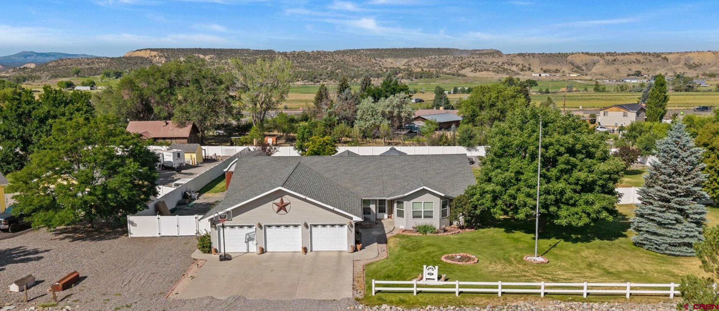 Wonderful River's Edge Ranch Estate with Versatile Floor Plan, Irrigation Water, Tons of Garage/Shop Space and RV Parking! Secure your slice of the good life with this Western Colorado dream property, which embodies so much of what makes life out here so good. Sitting on over an acre of beautiful, irrigated land, this ranch home is in an incredible location with close proximity to the mountains, as well as private access to the Uncompahgre River just blocks away in your own neighborhood. The kitchen has quality tile floors, multiple dining areas, tons of counter space and cabinetry, and an open layout, perfect for entertaining loved ones. The main en-suite is oversized and would accommodate extra furniture, reading nook, or a yoga mat with ease. It also has a huge walk-in closet, updated tile flooring in the en-suite bath with 2 spacious vanities. The floor plan also delivers an additional living room, which could be utilized as an office, or transformed into the entertaining den of your dreams! A large 3 car garage provides plenty of room for storing large vehicles and toys, and also has a partitioned room which could be the perfect home gym. Enjoy a bonus storage/shop in the backyard, which could the perfect spot for tinkering and projects! The large lot includes RV parking, allowing you to keep your toys, boats, trailers, and whatever else you're bringing with you on site! The sprawling, green and fully fenced backyard is an idyllic spot to enjoy everything this incredible climate has to offer. Serene and beautiful views in every direction and a massive covered back patio and pergola make this backyard the perfect spot to enjoy your favorite beverage. Don't sleep on a rare opportunity to get a foot in the door of an exquisite subdivision without breaking the bank. 1-Story, Ideal Floor Plan, Tons of Garage and Shop Space, RV Parking, River Access and Irrigation Water; Come Experience it For Yourself Today!