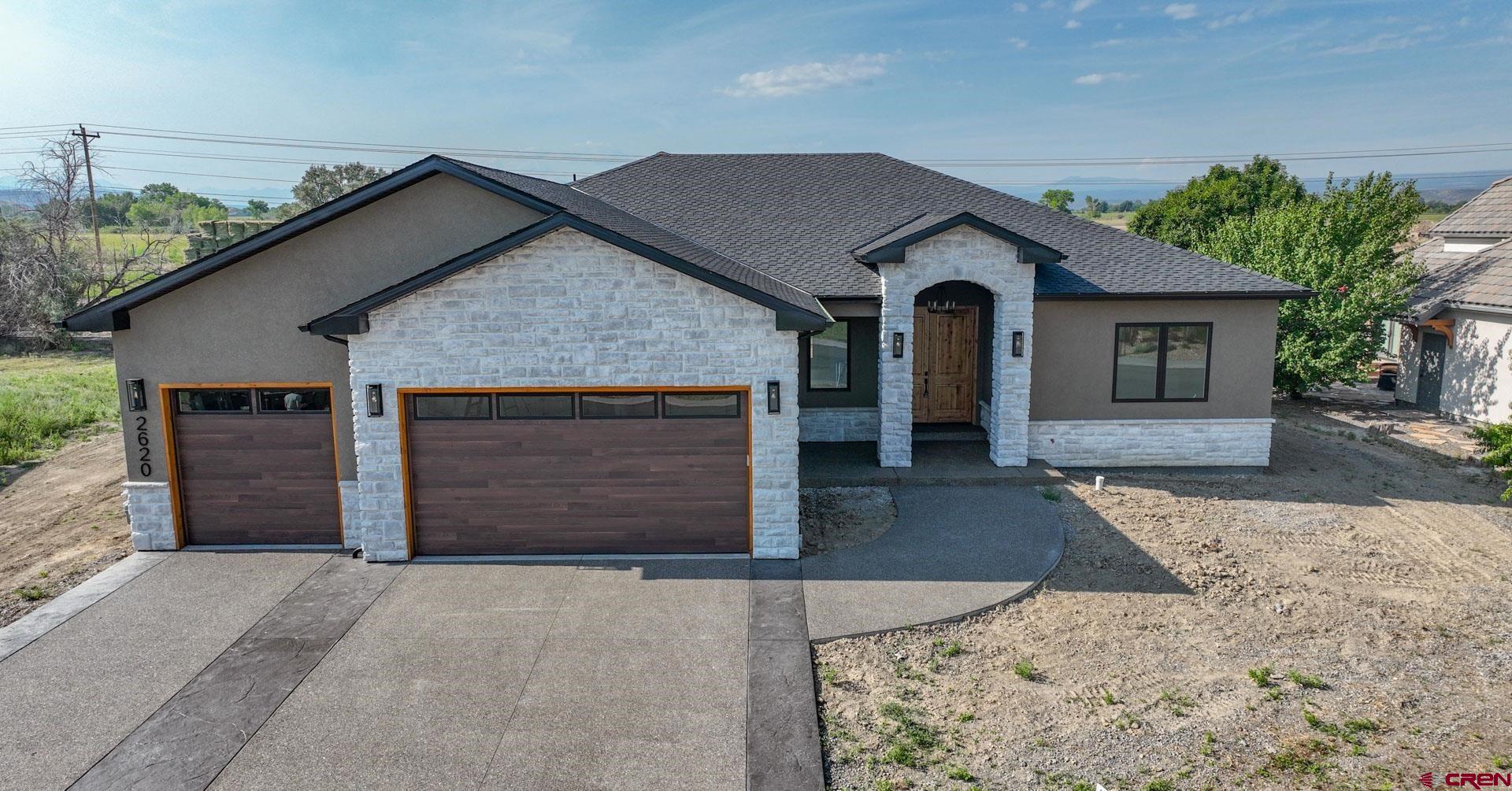 There’s another cut of builder who puts pride in every part of their new home. Every. Meet Alto Construction. A boutique builder whose master craftsmanship is top of the local residential construction class. Located in the prestigious Bridges Golf and Country Club community, this newly created masterpiece is a 3-bedroom, 2.5-bath, 2,170-SF home that will surely please even the most critical homebuyer. From the threshold, one enters through the expansive 8-foot, double, wooden doors, to an appreciation of this builder’s aesthetics throughout this split, open-concept floorplan designed to maximize its enviable panoramic views of the San Juan skyline. Mountain peak views translate easily to its high, 12-foot ceilings throughout the home bringing a vastness of vertical space. The kitchen is a culinary haven of custom, 10-foot, white-oak cabinetry capped by matching crown molding that pairs perfectly with the waterfall-quartz island providing ubiquitous storing options. Spice-specific cabinets and a stove-top pot filler are extra nice touches to delight the home chef. The builder took extra thought to marvelously naturally light the home. South-facing windows in the living and dining areas create nearly a wall of light to bathe the interior’s Level-5 finish as an artistic fresco. Besides the abundance of natural light, the living room’s ambiance is heightened from the electric fireplace surrounded by a wall of natural stone and a large-beamed pine mantle. Throughout the home, quality and vertical space are emphasized with solid, 8-foot doors. The primary bedroom enjoys San Juan views as well as dual walk-in closets that bring ample space. The bathroom is unlike you will ever discover: dual waterfall and handheld showers share the same tiled shower-pan with a classy tub separated by glass. Dual vanities and their quartz counters are strategically placed adjacent in a setting of floor-to-ceiling designer tiles. The builder was also very conscious of energy-savings and a quieter home environment with a premier combination of blown and spray foam insulation for damping sounds and maximizing energy efficiency. The conditioned crawlspace is double insulated – both wall and joists – as well as a radon-system installation, giving added comfort and peace-of-mind. The 3-car garage is fully insulated with R-31 insulation – keeping it warmer in the winter and cooler in the summer. The home’s driveway is textured and artistically stamped and colored for a bold curb presentation. Furthermore, the home’s cultured stone is widely used to accent the no-maintenance stucco. Premium roofing crowns the home with 30–40-year designer shingles. Lastly the covered back patio of stamped and colored concrete has a stained tongue-and-groove pine soffit for added appeal and set to gaze on the iconic San Juans. All this within walking distance to The Bridges Clubhouse and Remington Restaurant or 2-minute drive to the Montrose Rec District and a host of Montrose’s restaurants, shopping and dining establishments. The home is also poised as a basecamp of West-Slope adventures – from hiking, fishing, biking, hunting, four-wheeling, and more – every direction brings a new activity to choose from. Ready for the next level of home construction, premium views all in a resort-style setting? Come take a look; you won’t be disappointed!