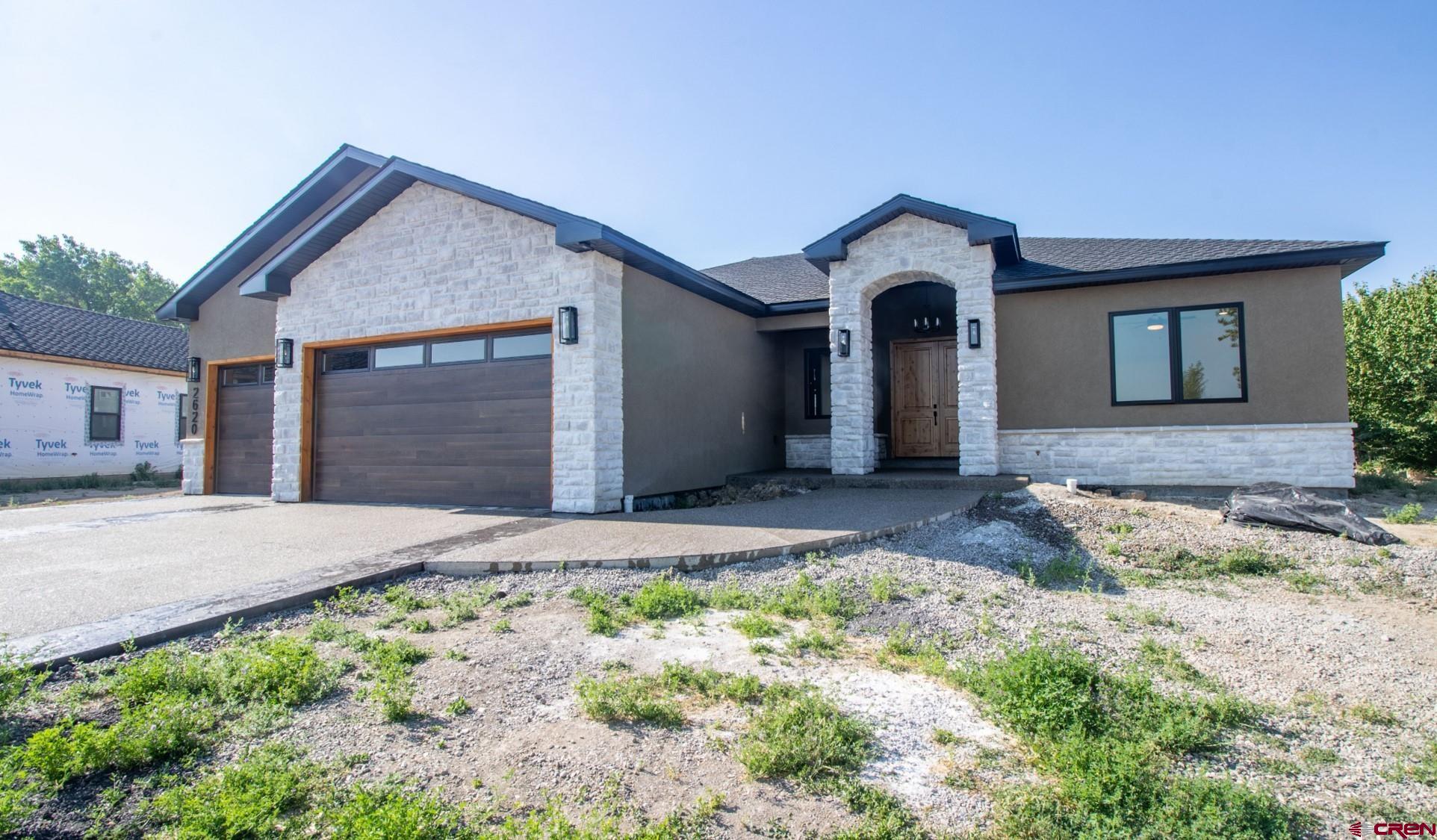 There’s another cut of builder who puts pride in every part of their new home. Every. Meet Alto Construction. A boutique builder whose master craftsmanship is top of the local residential construction class. Located in the prestigious Bridges Golf and Country Club community, this newly created masterpiece is a 3-bedroom, 2.5-bath, 2,170-SF home that will surely please even the most critical homebuyer. From the threshold, one enters through the expansive 8-foot, double, wooden doors, to an appreciation of this builder’s aesthetics throughout this split, open-concept floorplan designed to maximize its enviable panoramic views of the San Juan skyline. Mountain peak views translate easily to its high, 12-foot ceilings throughout the home bringing a vastness of vertical space. The kitchen is a culinary haven of custom, 10-foot, white-oak cabinetry capped by matching crown molding that pairs perfectly with the waterfall-quartz island providing ubiquitous storing options. Spice-specific cabinets and a stove-top pot filler are extra nice touches to delight the home chef. The builder took extra thought to marvelously naturally light the home. South-facing windows in the living and dining areas create nearly a wall of light to bathe the interior’s Level-5 finish as an artistic fresco. Besides the abundance of natural light, the living room’s ambiance is heightened from the electric fireplace surrounded by a wall of natural stone and a large-beamed pine mantle. Throughout the home, quality and vertical space are emphasized with solid, 8-foot doors. The primary bedroom enjoys San Juan views as well as dual walk-in closets that bring ample space. The bathroom is unlike you will ever discover: dual waterfall and handheld showers share the same tiled shower-pan with a classy tub separated by glass. Dual vanities and their quartz counters are strategically placed adjacent in a setting of floor-to-ceiling designer tiles. The builder was also very conscious of energy-savings and a quieter home environment with a premier combination of blown and spray foam insulation for damping sounds and maximizing energy efficiency. The conditioned crawlspace is double insulated – both wall and joists – as well as a radon-system installation, giving added comfort and peace-of-mind. The 3-car garage is fully insulated with R-31 insulation – keeping it warmer in the winter and cooler in the summer. The home’s driveway is textured and artistically stamped and colored for a bold curb presentation. Furthermore, the home’s cultured stone is widely used to accent the no-maintenance stucco. Premium roofing crowns the home with 30–40-year designer shingles. Lastly the covered back patio of stamped and colored concrete has a stained tongue-and-groove pine soffit for added appeal and set to gaze on the iconic San Juans. All this within walking distance to The Bridges Clubhouse and Remington Restaurant or 2-minute drive to the Montrose Rec District and a host of Montrose’s restaurants, shopping and dining establishments. The home is also poised as a basecamp of West-Slope adventures – from hiking, fishing, biking, hunting, four-wheeling, and more – every direction brings a new activity to choose from. Ready for the next level of home construction, premium views all in a resort-style setting? Come take a look; you won’t be disappointed!