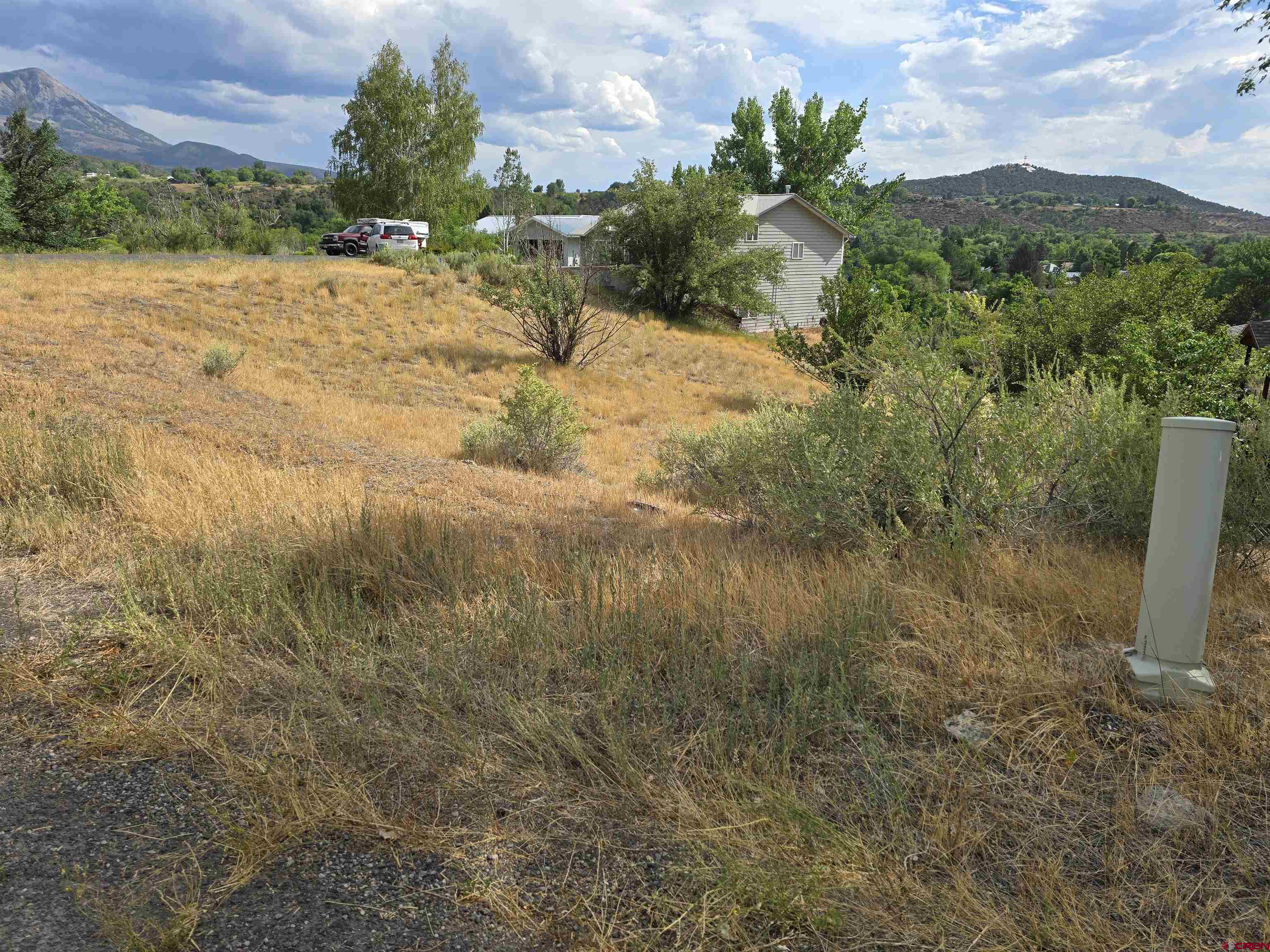 Vacant land in Paonia is increasingly rare! Here is your opportunity to build your own home on this .13-acre lot located in a desirable subdivision close to Mt. Jumbo trailhead, Town Park and the bustling downtown. The real beauty in this location is the short trail right out your back door where you find yourself in Paonia's sweet little Apple Valley Park, with its new playground, tennis courts, walking path, exercise stations, covered picnic tables and Minnesota Creek that runs along the park. The property is located on a cul-de-sac, with beautiful views of the West Elks, P-Hil and the North Fork Valley to the west. Irrigation water is supplied by the HOA, water and sewer taps are included and installed. Electric and gas are at the property line, ready to go. What are you waiting for?