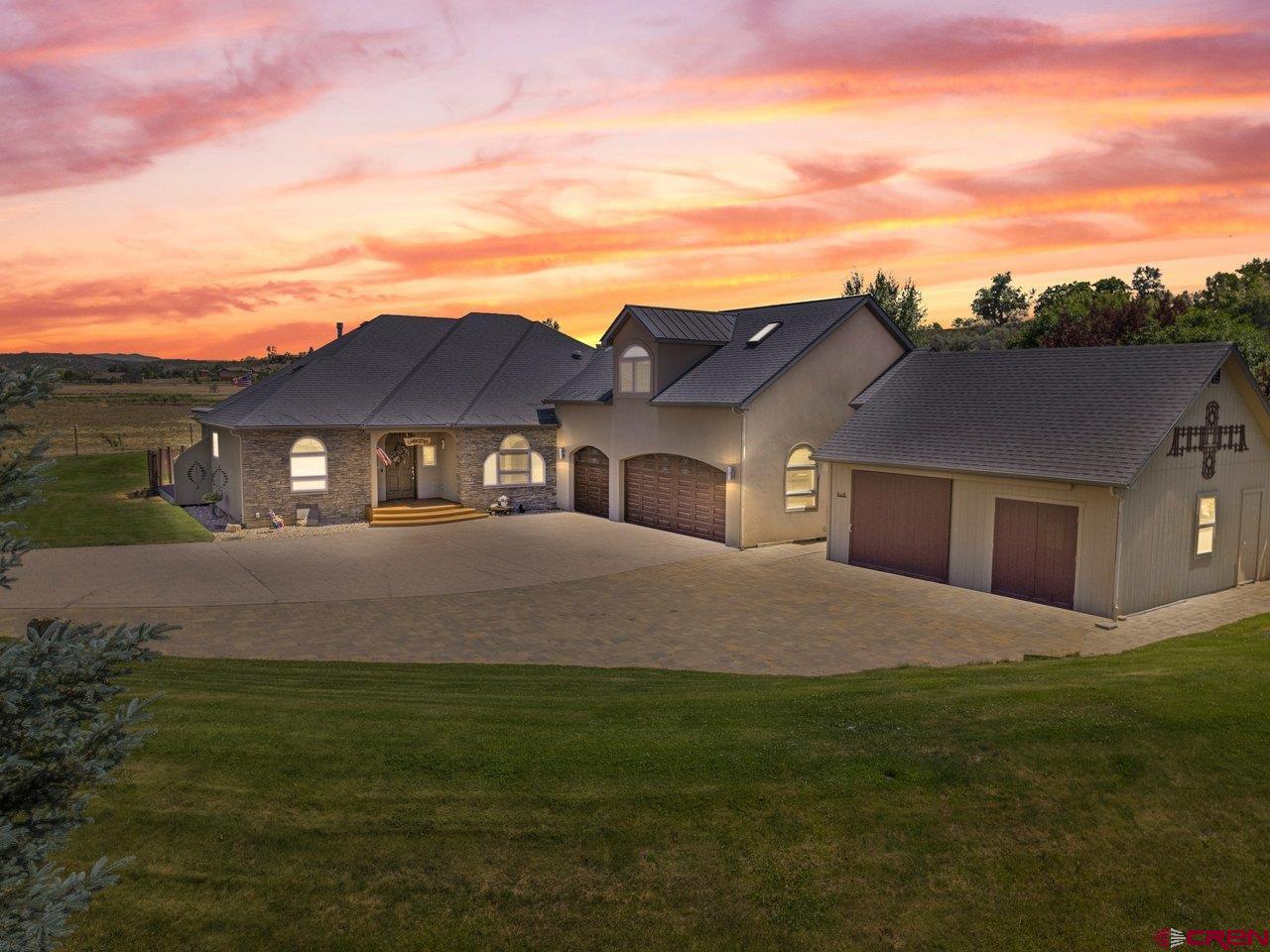 Refined Mountain Living – Style, Space & Unmatched Craftsmanship  Welcome to 63200 Percheron Court, where modern luxury meets quiet Colorado living. Tucked away on a private cul-de-sac just minutes from town, this meticulously designed residence sits on 1.37 beautifully landscaped acres.  Step inside to over 2,900 square feet of thoughtfully curated living space, where comfort, style, and function blend seamlessly. The heart of the home—the chef’s kitchen—has been fully remodeled with Wolf and Sub-Zero appliances, Brazilian granite countertops, steam and conventional ovens, a pot filler, and an instant boiling/filtered water system. Whether you're cooking for two or hosting a crowd, this space delivers gourmet-level performance with timeless style.  Unwind in the expansive bonus room above the garage, featuring a custom bar, skylights with remote-controlled shades and ventilation, and direct roof access—perfect for star-gazing or summer evenings above it all.  Built with comfort and efficiency in mind, the home features in-floor radiant heating, central HVAC, individual thermostats in every room, solar-powered attic fans, and a partially heated driveway and patio to keep winter worry-free. Additional amenities include a central vacuum, on-demand hot water, water softener, radon mitigation system, and a state-of-the-art roof ice melt system. Outside, enjoy serene moments by your private backyard pond with dual waterfalls, or relax under any of the five automatic awnings that provide shade at the touch of a button. The 33’ x 33’ detached shed offers excellent space for a workshop, RV/boat storage, or future studio.  The oversized 3-car garage features epoxy flooring and a secure fireproof vault with an alarm system—ideal for storing valuables or documents. A full home security system adds even more peace of mind. This home is approximately 75 minutes away from Telluride and approximately 105 minutes away from Crested Butte. Don’t wait, call your favorite agent for a showing today!