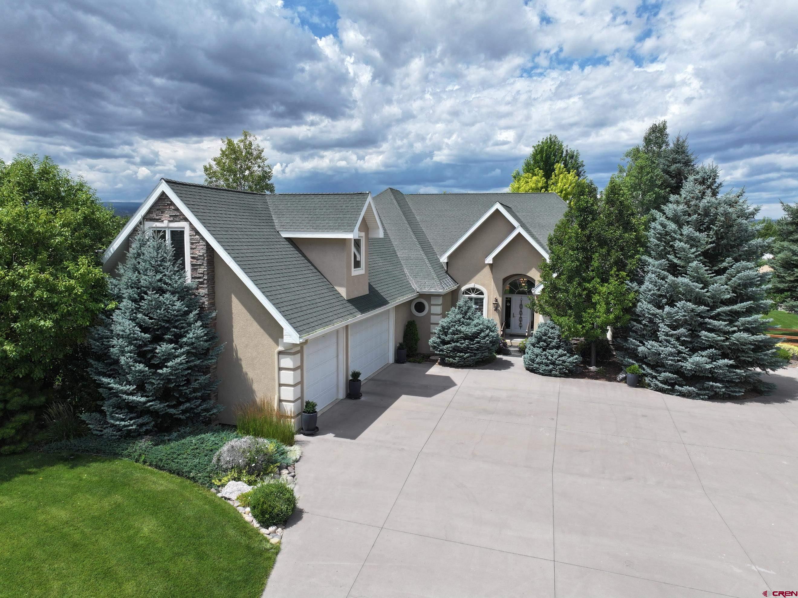 Perfection to a T — This modern-style home blends comfort, elegance, and high-end design, all nestled within one of the area's most prestigious neighborhoods: Quail Creek Ranch.  Step through the inviting front entry into a spacious open-concept living area and formal dining room. The main level features 3 bedrooms and 2.5 baths, along with an oversized bonus room, located above the attached 3-car garage.   The custom kitchen is both stylish and functional, with elegant cabinetry, granite tile countertops, stainless steel appliances, a raised bar for seating, and convenient pull-out drawers. It flows seamlessly into the cozy family room, complete with a gas fireplace for those cool Colorado evenings.  The primary suite is truly a retreat, offering two separate walk-in closets, a spacious ensuite bathroom, and a large linen closet for added storage.  Step outside to your private outdoor oasis. The covered concrete patio boasts two separate seating areas overlooking a beautifully landscaped yard with mature blue spruce and aspen trees, colorful annuals and perennials, and a lush, green lawn. The yard is fully fenced and offers an exceptional level of privacy.  Adding to the appeal is a detached 4-car garage, complete with a half bath and a finished bonus room above — perfect for a studio, guest quarters, or home office.