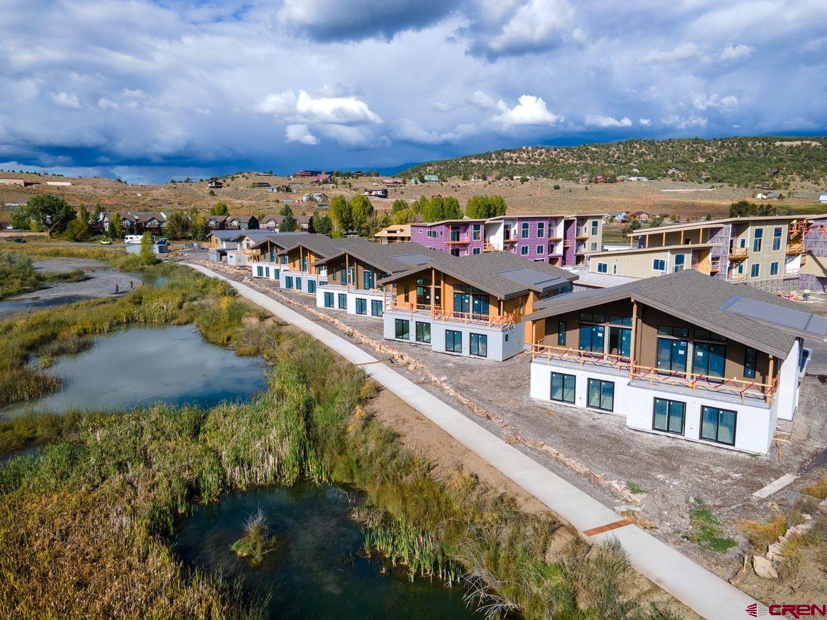 Placed in an ideal location along the banks of the Uncompahgre River, Riverfront Village offers the only riverfront residences in the town of Ridgway. Open space across the river brings privacy and tranquility to residents. These mountain modern condominiums and duplexes range from 2 to 3 bedrooms and include 2-car garages. They also boast alpenglow vistas to the east and evening sunsets dancing across the river to the west. Natural textures are complemented by warm, neutral accents for the perfect blend of polish and comfort. Walk, bike, or jog along the recreation path that leads from Riverfront Village to downtown dining and shopping options as well as Ridgway State Park and Ridgway Reservoir. Nestled in the Uncompahgre Valley ringed by the Cimarron Mountains, call Ridgway Home.