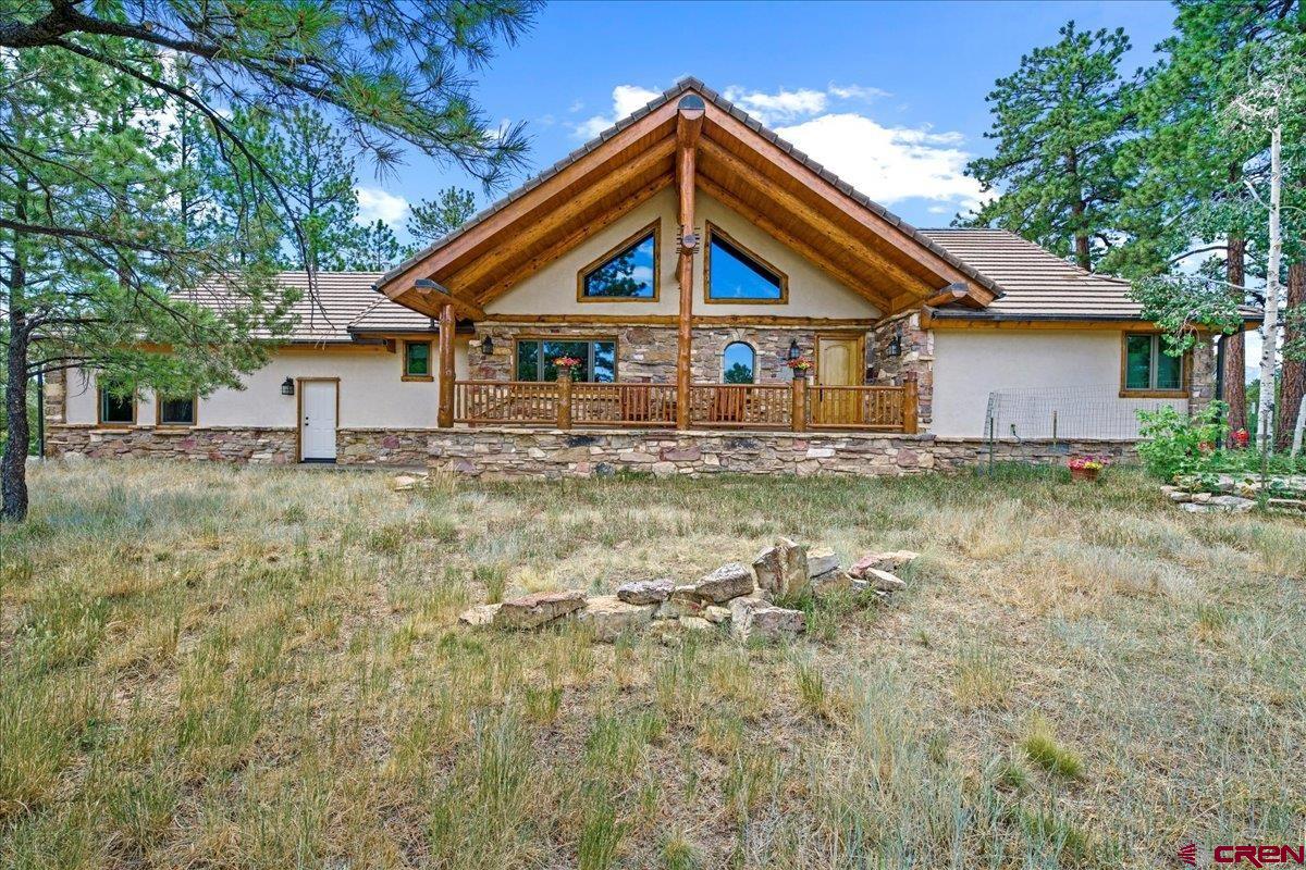 Nestled on the Golf Course amongst towering Ponderosa trees this 2767 sqft  home offers Mountain View’s and spacious indoor and outdoor living. Enjoy single level living with everything you need on the main floor.  The home features open concept living with a stunning gas fireplace, Gourmet Kitchen and Primary en-suite all with access to the large mountain modern deck with steel railings and posts.  There is also an ample laundry room on the main level with storage and a half bathroom leading to the spacious garage. Real hardwood flooring and tile throughout the home as well as many details including a gorgeous ceiling liner and wood trim/doors give it a cozy mountain feel.  Downstairs is a walkout basement with gorgeous stone patio area, another bedroom , bathroom , wet bar and an additional living space currently serving as a second living room, office area and a weight room.  This area could easily be used as a 3rd bedroom with flex space for extra family and friends.  Located in Divide Ranch and Club Golf Course community with easy access to the Montrose airport, World renowned ski resort in Telluride, Hot springs in Ouray and the quaint town of Ridgway there are endless outdoor activities for all.  Enjoy golfing, fishing, hiking, jeering, paddle boarding or rafting and so much more. Truly experience outdoor living watching the wildlife on your back deck.