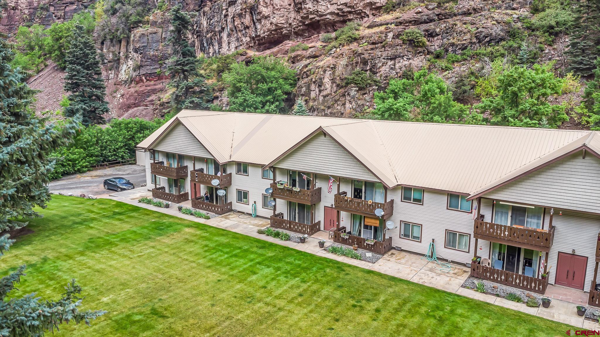Your private Mountain Getaway right in the heart of Ouray, Colorado -- also known as "The Switzerland of America!" This adorable ground-level Lock-n-Leave 2 bedroom, 1 bath condo boasts 360-degree MOUNTAIN VIEWS GALORE! Although it has a private location setback close to the mountain, it's also only short walking distance to the Ouray Hot Springs, Ouray Perimeter Trail, and all the shops, restaurants, and fun right in town! Sit out on your private covered patio overlooking your giant grassy common area with trees, wildlife, and 'knock-you-over' mountain views. The condo has new flooring professionally installed in November of 2024 and a new vanity in the bathroom. The giant great room provides all kinds of possibilities, and both bedrooms are spacious w/gorgeous views out the windows. The eat-in kitchen is perfect for relaxing in your own space to prepare meals or just sit in your built-in table next to the window and mountain views that are beyond phenomenal. There is a nicely sized designated covered parking w/additional storage, and a common patio & BBQ area right under the mountain. The HOA takes care of snow removal, lawn care, and exterior maintenance at a low monthly $150/month fee. So you really CAN throw all your worries to the wind and just enjoy your life at this incredible property. This would make a terrific 2nd home residence or primary residence, or even an investment property. Ouray is known for it's world-class Jeeping, hot springs, rock climbing, ice-climbing, Via ferrata, hiking, biking, festivals, you name it! And it's close to Telluride Ski Resort, known as one of the best in the world! Ouray is oftentimes described as a little piece of Heaven on Earth. Come home to 2101 MainStreet A-2, and feel the joy of what life can actually be! Buyer to verify all info and measurements.
