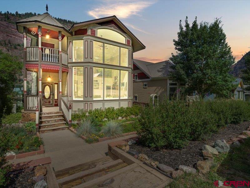 Live the Mountain Town Dream – Luxury Victorian in Ouray, Colorado  Welcome to your dream retreat in the heart of the San Juan Mountains. This elegant modern Victorian, built in 2003, blends classic design with contemporary comfort—all set against 270-degree panoramic views that change with the seasons.  Wake up to golden morning light spilling through the two story living room windows. Enjoy coffee on your turret deck, or west deck, whichever view you choose.  Both east and west sides have incredible mountain views.  The east side has two story windows and looks out at the Amphitheater, the west side sunroom views encompasses Abrams, US mountain, Mt. Hayden and Twin Peaks.  Inside, the heart of the home features labradorite countertops that shimmer like the night sky, complemented by custom cabinets and spacious work space.  The gas log fireplace in the den provides a nice warm glow while adding a little more heat on the chilly winter days.  The sunroom on the west side have excellent views of US Mountain and the west cliffs of Twin Peaks.  With 4 spacious bedrooms, and three full baths plus a half bath, there’s room for family and friends. The primary suite is a serene escape, while the open-concept living areas offer cozy corners and effortless flow. The two-car attached garage adds everyday convenience, and the low-maintenance xeriscape yard gives you more time to explore the trails, hot springs, and charming streets of Ouray.  The stone retaining walls provide nice separation between your neighbors.  The driveway has ornate pavers that keep the dirt out of the garage.    This isn’t just a home—it’s a basecamp for adventure and a sanctuary for relaxation, all in one of Colorado’s most iconic mountain towns.