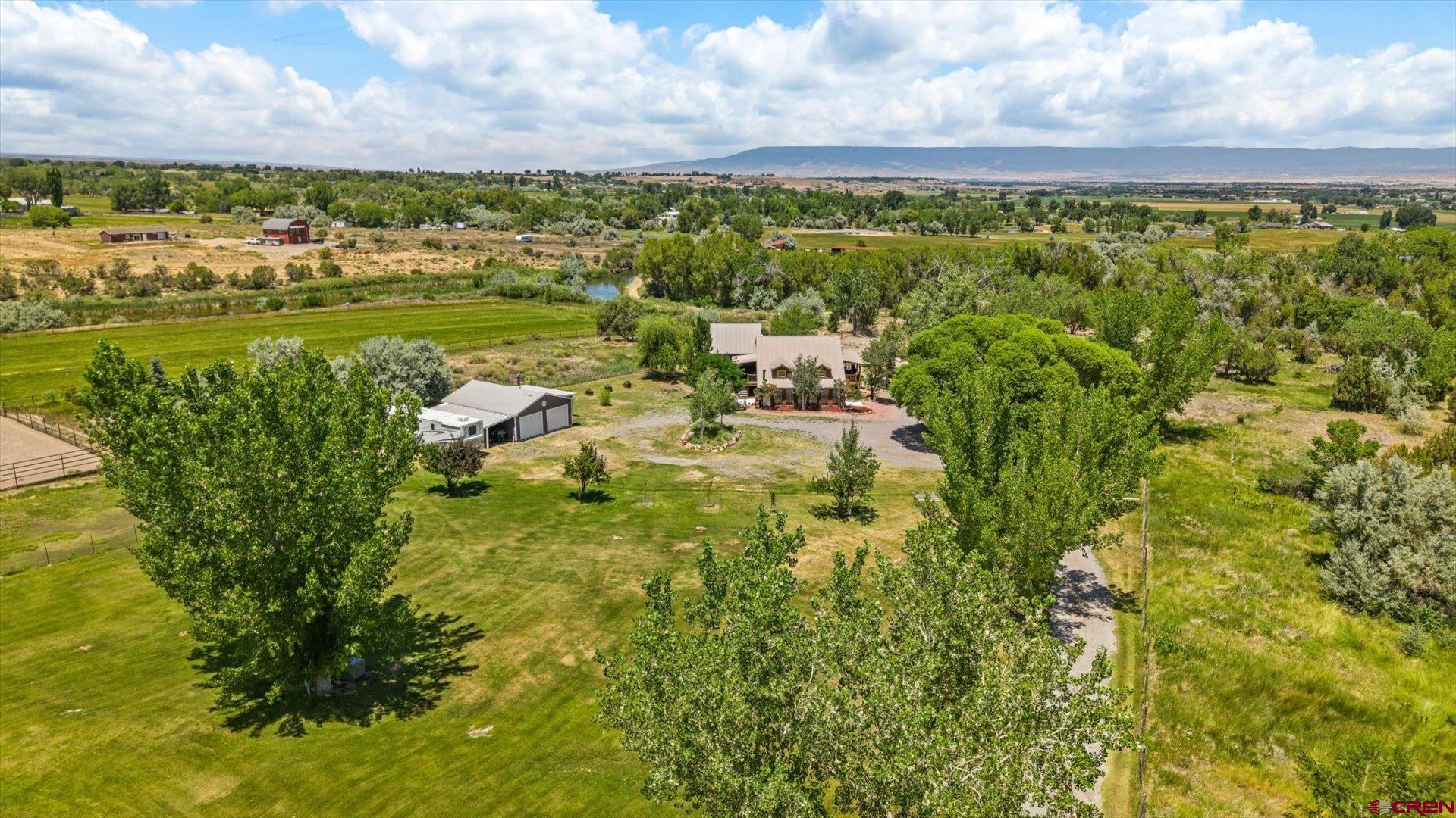 A Private Retreat Just Minutes from Town – Extensively remodeled, this Spring Creek Serenity is a MUST SEE!  Tucked away on nearly 2 acres in the highly sought-after Spring Creek area west of Montrose, this extraordinary home offers the rare combination of true privacy and convenient proximity. Just minutes from downtown, the hospital, schools, airport, and shopping, you’ll feel worlds away while enjoying the peace and serenity of a rural country setting. Surrounded by mature trees, open space, and the gentle flow of the UVWUA canal along its north side, this property embraces you with a sense of calm the moment you arrive.  Custom-designed and modernized to take full advantage of its location, the home’s style evokes the charm and craftsmanship found in Colorado’s most coveted resort towns such as Ridgway, Ouray, and Telluride. From the moment you step inside, the thoughtful blend of wood, tile, stone, metal, and color  creates an atmosphere of warmth and sophistication. Natural light pours through expansive windows, enhancing the home’s open yet intimate feel.  Every inch of this 3,000+ square foot residence has been impressively remodeled with intention. The main level showcases an open kitchen and living space anchored by a grand 13-foot oak island, coffee bar, stainless steel appliances, and a striking rock fireplace that burns natural gas. The master suite is a sanctuary in itself, featuring a spectacular copper soaking tub and its own laundry. A south-facing sunroom with radiant floor heat welcomes you with passive solar warmth, while multiple decks—including one with an outdoor shower—create a seamless connection to the outdoors.  This is more than just a home—it’s a property designed for flexibility. The walk-out lower level functions as a private apartment with its own entrance, kitchen, laundry, and living room—ideal for multi-generational living, guest accommodations, or income potential as a rental or Airbnb.  Outside, you’ll find an outdoor kitchen with a pizza oven, a rock patio, garden spaces, and a detached 2-car garage/workshop. Covered trex decks on both sides of the home invite relaxation year-round. Modern comforts like newly installed mini-splits, radiant floor heat, and a durable metal roof add to the appeal.  This is not your average home. It’s a one-of-a-kind retreat where every detail has been carefully chosen to inspire comfort, creativity, and connection—inside and out. Once you step through the door, you’ll understand why it’s so special.