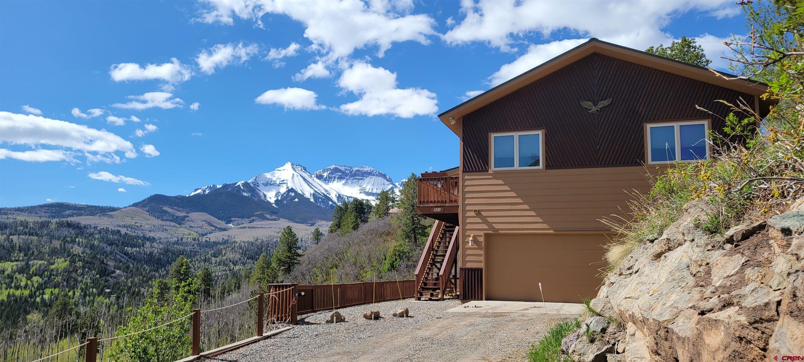 A Private Mountain Escape Above Ridgway  Just above the charming mountain town of Ridgway, Colorado, lies a property that feels like it was designed for those who want it all: privacy, comfort, and a front-row seat to the beauty of the San Juan Mountains. At the very edge of Elk Meadows, on two wooded acres, this home sits at the end of a quiet road where the only interruptions are the sound of wind through the trees and the sight of endless mountain vistas.  From the moment you arrive, the setting invites you to slow down and breathe deeply. Step onto the expansive deck in the morning with a warm cup of coffee and watch the first light spill over the peaks. In the evenings, gather with friends and family as the sky turns brilliant shades of orange and pink while the sun dips behind the mountains — a daily reminder of why people dream of living here.  The home itself is warm, welcoming, and designed with both function and efficiency in mind. Offering 3 bedrooms and 3 bathrooms, it is spacious enough for family and guests, yet intimate enough to feel like a true retreat. Sunlight pours through large windows, framing picture-perfect views from nearly every room. The thoughtful details elevate the living experience — from in-floor radiant heating that keeps the home cozy in winter, to smart-home remote security, surround-sound built-in speakers, and energy-efficient appliances. Every modern amenity is in place, making this a turn-key property that is not only well-appointed, but also fully furnished and ready to be enjoyed.  This residence has proven itself as a versatile mountain home — ideal for full-time living, a second home escape, or as a successful short-term rental with a history of income. Its location is unbeatable: minutes from Ridgway’s art galleries, restaurants, and Ouray's hot springs, and less than 45 minutes to Telluride, where world-class skiing and year-round festivals await. Outdoor recreation is at your doorstep, with opportunities for hiking, biking, ice climbing, snowmobiling, and exploring the countless trails and natural wonders of the region.  Life here is about balance. It’s mornings filled with crisp mountain air, afternoons spent adventuring, and evenings gathered on the deck beneath a canopy of stars. It’s privacy without isolation — a place where you can recharge while still being close to all the culture, community, and recreation that make southwest Colorado one of the most desirable places to live.  This is more than a home — it’s a lifestyle, a sanctuary, and an opportunity to own a piece of the San Juans. Whether you are seeking a full-time mountain residence or a getaway that pays for itself when you’re away, this property is ready to welcome you home.