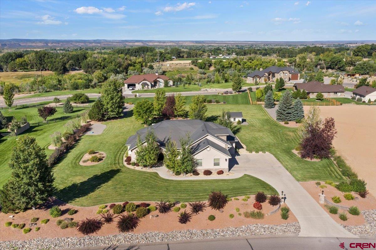 Rare find in the prestigious Quail Creek Subdivision! This custom built home is 3308 sqft, with a spilt floor plan and perfectly set on 1.5 acres.  Upon entering the home you will be welcomed with a formal dinning room, as well as french doors to an office that has plenty of natural light. The kitchen has granite countertops including an island, custom cabinets, stainless steel appliances, a gas range plus two convection ovens, and countertop eating area. The master-suite has its own private access to the covered back patio, and the master bath has 2 separate walk in closets, a jetted tub, double sinks and granite counter tops.   All bedrooms are located on the main level, have walk in closets, plenty of space and privacy. Upstairs you will find a bonus room that can be used as a family-room, work out room, art studio, man-cave and so much more.   This property has a beautifully landscaped yard to enjoy the views of the San Juans Mountains, Grand Mesa and the Uncompahgre Plateau. You won't want to miss this opportunity, schedule your showing today!
