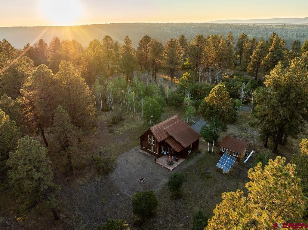 Tucked away on the serene and scenic Hastings Mesa, this nearly 10-acre property is the perfect retreat for those seeking peace, quiet, and the beauty of nature. Hastings Mesa delivers—with bonus bird choir. (They rehearse daily. Free concert.) Breathtaking views of Hayden Peak can be enjoyed through the cabin’s expansive picture windows. This thoughtfully designed cabin features a lofted bedroom, a full bath, and a full kitchen so you can finally use the cast iron skillet you panic bought during lockdown. With the essential infrastructure already in place, including a well, septic system, and solar power, the foundation for your mountain escape is complete.  Two sheds included, because obviously your mountain lifestyle requires excessive gear storage (and let’s be honest, probably one shed just for half-used paint cans). The cabin itself awaits your finishing touches—an opportunity to personalize the details and truly make it your own.  Whether you’re searching for a weekend getaway or a long-term haven, this Hastings Mesa property offers the perfect blend of seclusion, comfort, and potential.