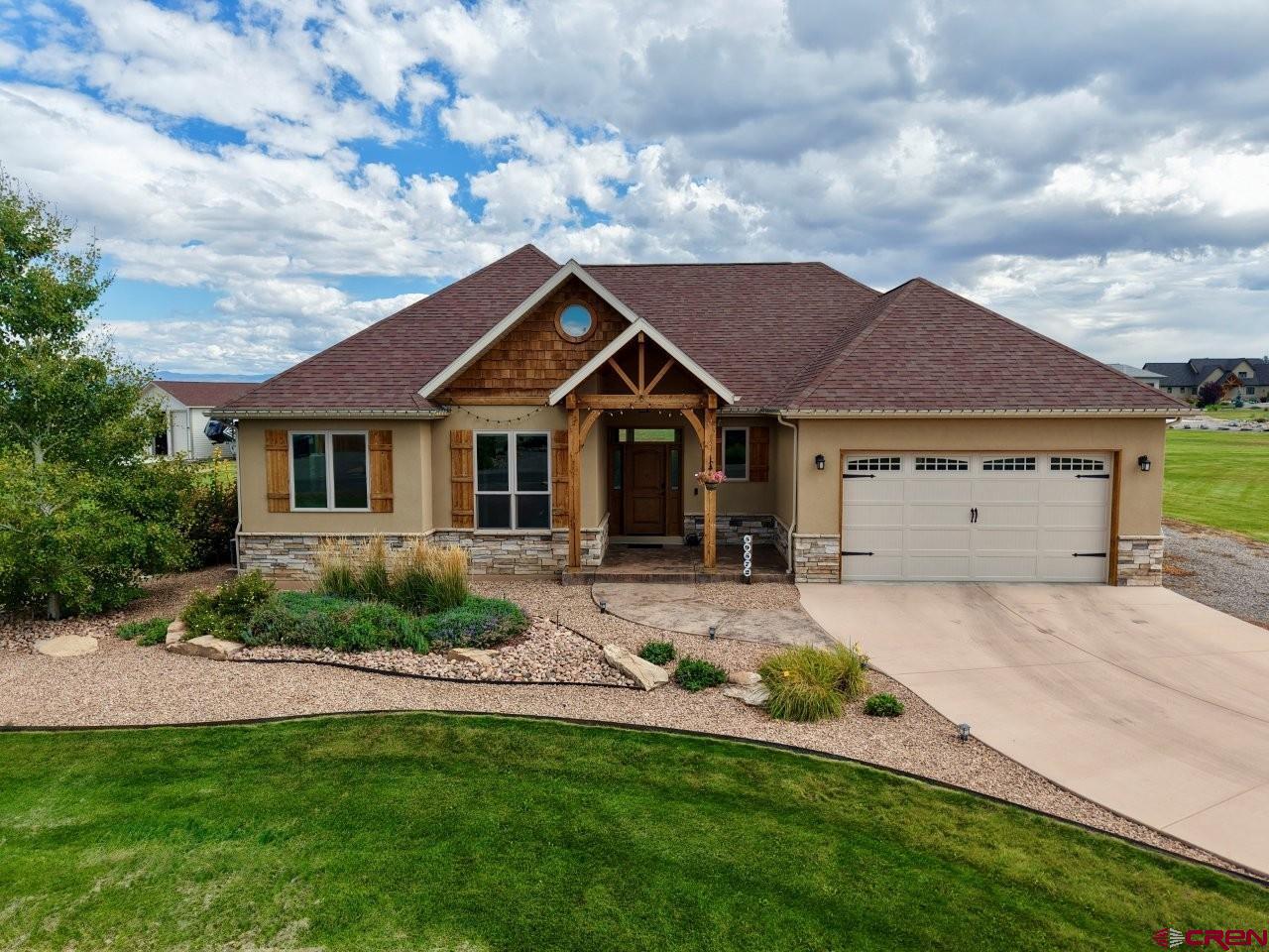 Spectacular custom home in Dakota Vista Subdivision on Spring Creek Mesa.  This charming one-level home is located on a beautiful setting with mountain views, fenced dog yard, mature landscaping and irrigation water.  This home features hardwood floors in the main living area, Alder cabinets throughout, granite countertops, Bosch kitchen appliances, pantry, gas fireplace, solid wood interior doors and trim, vaulted ceilings, T&G ceiling in sunroom, laundry room sink, tile floors in kitchen/entry/laundry and bathrooms.  Primary suite offers walk-in shower, double vanity sinks, and walk-in closet.  The heated 2-car garage features a floor drain, hot and cold faucet, and an additional 10'x17' tandem bay that can be used for ATV's, shop area, or additional storage.  Additional features include stucco & stone exterior, conditioned crawlspace, over excavated foundation, block insulated foundation, humidity-controlled A/C system, covered back patio with ceiling fan and gas stub plus and additional uncovered back patio area and RV parking with hook-ups.  This remarkable property a MUST SEE!