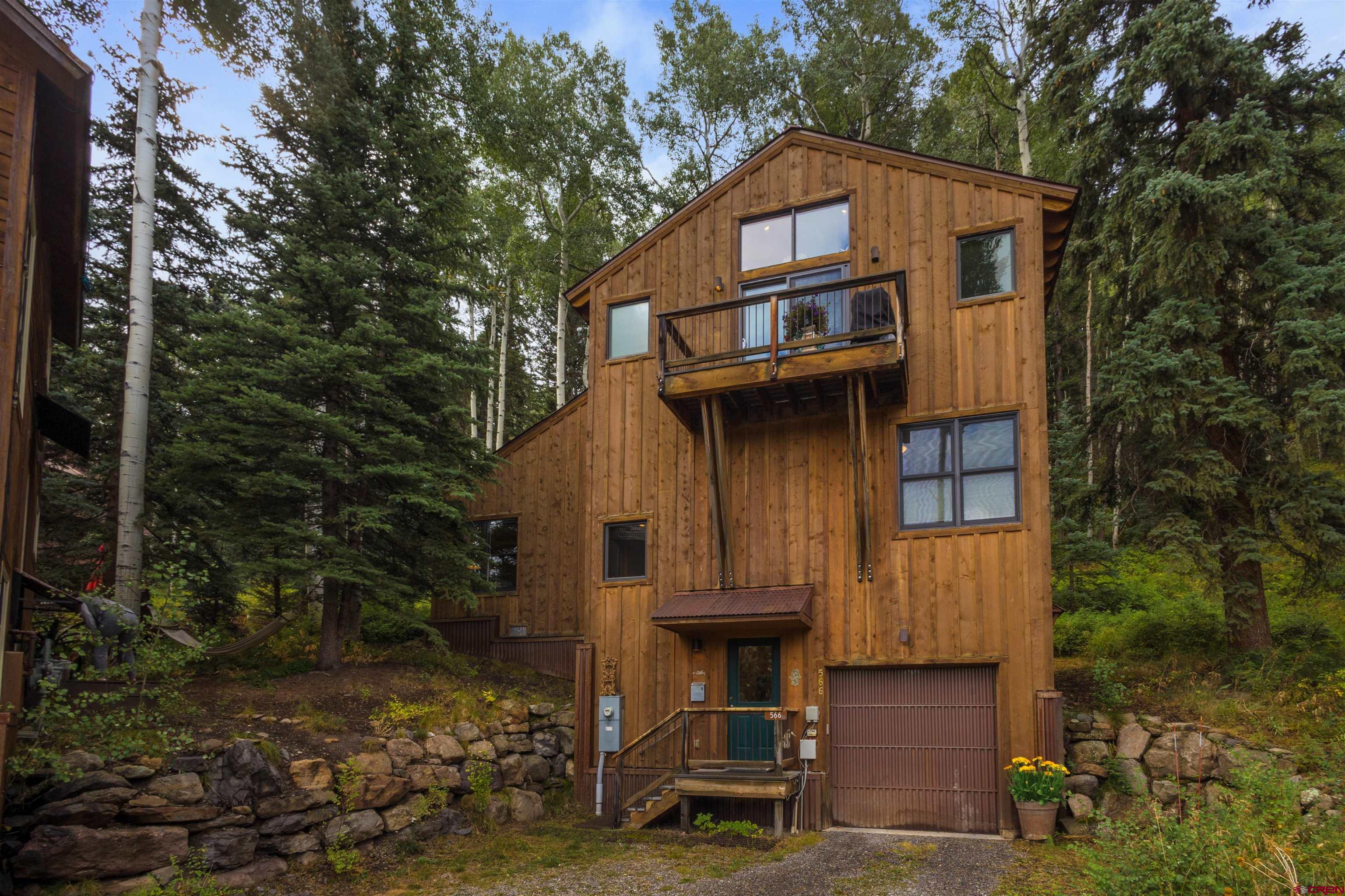 A true local's home - deed restricted!  Welcome to this beautifully maintained residence in Lawson Hill, offering three spacious bedrooms, two and a half bathrooms, and an oversized one-car garage. The third-floor living and kitchen area showcases stunning views of the San Sophia Ridge, filling the space with light and mountain scenery. Backing up to National Forest, the home provides a serene, treehouse-like setting with the perfect balance of privacy and charm. Warm, inviting, and thoughtfully cared for, this is a rare gem in Lawson Hill - come see it for yourself!