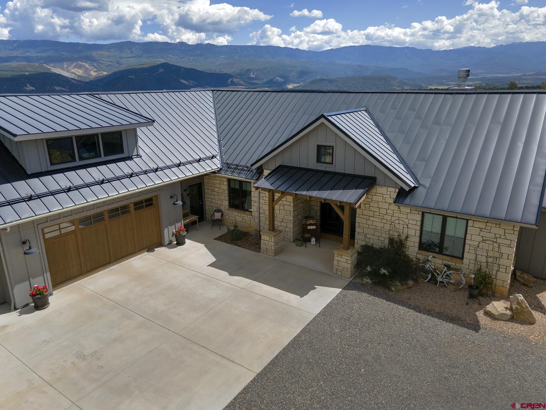 Do not miss this stunning Log Hill home situated on over four acres, thoughtfully designed to maximize Cimarron views and constructed by renowned local builder, DCI Construction in 2020. This home features three main floor bedrooms and an office/TV room. The expansive covered patio is designed to take in all that the Colorado lifestyle has to offer and is perfect for entertaining and taking in evening Alpenglow. A bonus room with in-floor radiant heating above the expansive three car garage overlooking Mt. Sneffels can be used for anything that fits your needs. Light and bright, the open concept great room is showcased by a stone fireplace with a mantle fabricated from wood salvaged from an Ohio log cabin. Hickory wood floors create depth throughout. The gourmet kitchen features designer cabinets, an expansive island, and high-end appliances. The primary suite boasts Cimarron views, a steam shower, claw foot tub and an oversized walk-in closet located right next to the laundry room. The two guest bedrooms, adjoined by a Jack and Jill bathroom, round out this architectural treasure. Property corners to open space owned by the county allowing access for a variety of outdoor activities year-round. This treasure won't last.