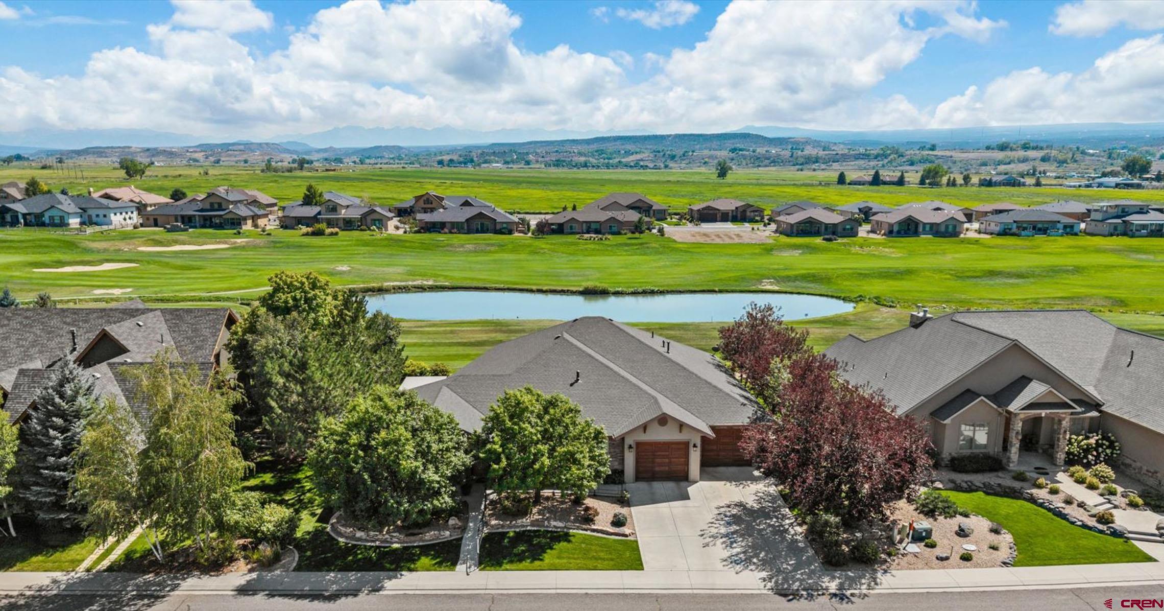 Masterful and Pristine Cobble Creek Estate with Mesmerizing Mountain Views, 2 En-Suites, Elevated Finishes and All on One Level! You've been waiting for it and now it's here, over 3,000 strategic and spacious square feet of pure mystique, class, and luxury. Sleek hardwood floors draw you into a polished setting, where upscale design shines in every detail. Zero-entry convenience secured, a perfectly apportioned split floor plan with 2 gorgeous en-suites, and fantastic character and finishes throughout. The kitchen is a chef-entertainer's dream and delivers massive amounts of counter space and storage in custom wood cabinets, a generous island with plenty of extra seating, on-trend granite countertops and an ergonomic layout. Watch the turning of the seasons upon majestic Rocky Mountains peaks from the comfort of your Colorado-inspired, elevated living room with a huge stone fireplace, gallery-style windows, and a full bar with a wine cooler included. Watch the big game and host all of your loved ones with room to spare, this unique and custom-designed floor plan has it all. En-suite number 1 captures massive views, provides extra room to accommodate additional furniture or room for a yoga mat, includes 2 separate walk-in closets, a beautiful tiled walk-in shower and soak tub. En-suite number 2 doesn't compromise on finishes and provides privacy, ensuring guests and loved ones a luxurious experience through and through. The laundry room is a haven in itself, allowing you to keep the mess out of sight and comes with a huge amount of cabinetry, storage, and non-claustrophobic space to make tidying up a breeze. In addition to 3 well-designed bedrooms, wander around and discover the bonus room you never knew you needed. Hobbies, crafts, an epic den/game room, room for the littler loved ones, great natural light and quality views, a mind-blowing walk-in closet to store anything and everything you're bringing with you, this space is next level and is primed to enable you to live the life you want. In addition to this, you have an oversize garage with a full golf cart bay and an additional storage area. Step outside to rolling green fairways framed by other-worldly views and surroundings. A quiet pond with a creek flowing by, wildlife all around, rose bushes and aspens whispering in the wind, your favorite beverage will hit differently soaking in these surroundings. Possibly the best part about this home is its location; the level of amenity and convenience are unrivaled in Montrose, Colorado, as well as in the desired neighborhood of Cobble Creek specifically. Take a short walk to a yoga class and lavish spa service, or sip your favorite beverage with friends at the Tavern. Mile upon mile of walking paths and parks exist right out your front door, while Montrose maintains extremely high standards of health care, quality of life, a diverse and budding restaurant and brewery scene, all at the base of arguably the most picturesque mountain range in the United States. Unmatched Luxury Living in an Enchanting Atmosphere with Amazing Amenities; What Are You Waiting For?