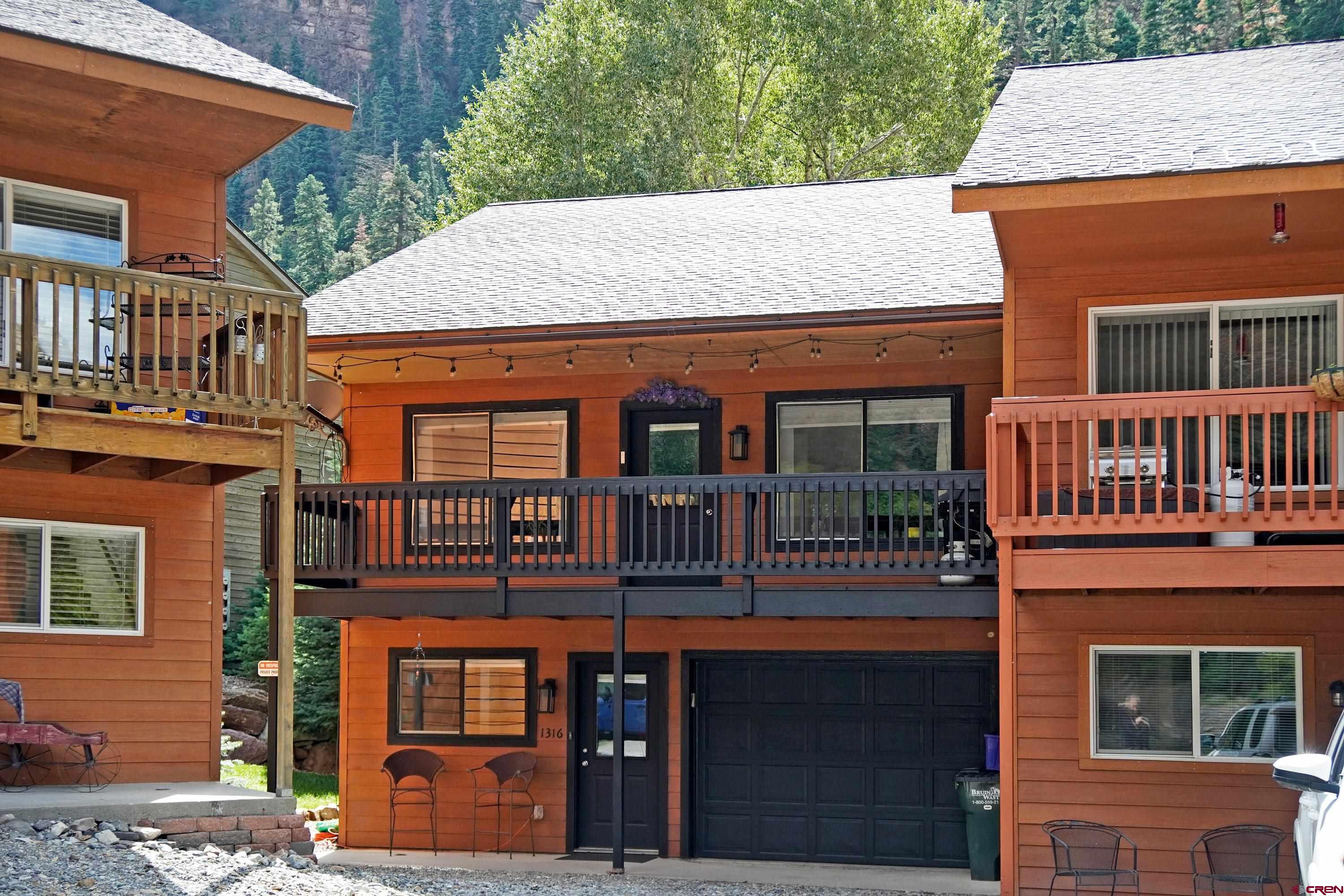 Have you been searching for the perfect home in Ouray—a property that not only offers a cozy retreat for you and your loved ones, but also delivers outstanding investment potential? This fully furnished, move-in ready townhome on the banks of the Uncompahgre River offers exactly that—and so much more.  Unlike many complexes in town, this property comes with no HOA fees and no restrictive covenants. That means you’ll save thousands over the years compared to similar properties, while also enjoying the flexibility to use your home as you choose. With the City of Ouray’s proper permitting, you can operate both short-term rentals (VRBO, Airbnb) and long-term rentals, creating an exceptional income-producing investment property in the heart of Colorado’s San Juan Mountains.  Inside, the spacious layout is designed for comfort and functionality. The upper level features a bright living room, dining area, kitchen, full bath, and a primary bedroom with a private riverfront deck. The entry level offers two additional bedrooms, another bath, and an oversized, fully finished garage with ample space for all your outdoor gear—bikes, skis, kayaks, and more. Outside, a large front deck offers stunning views of Gold Hill, while the back patio sits right on the river’s edge—perfect for relaxing after a day of adventure.  Location is everything, and this end-unit townhome has one of the best spots in Ouray. Just steps from the North Ouray Corridor Trail and minutes from the famous Ouray Hot Springs Pool, you’ll have endless access to hiking, biking, fishing, and year-round mountain adventures. With its private corner position, you can walk directly along the side of your home to the river trail, making outdoor living effortless.  Whether you’re looking for a personal mountain getaway, a vacation rental investment, or a full-time Colorado residence, this unique Ouray property checks every box. Don’t miss your chance to own a rare riverfront home with unbeatable lifestyle and income potential.