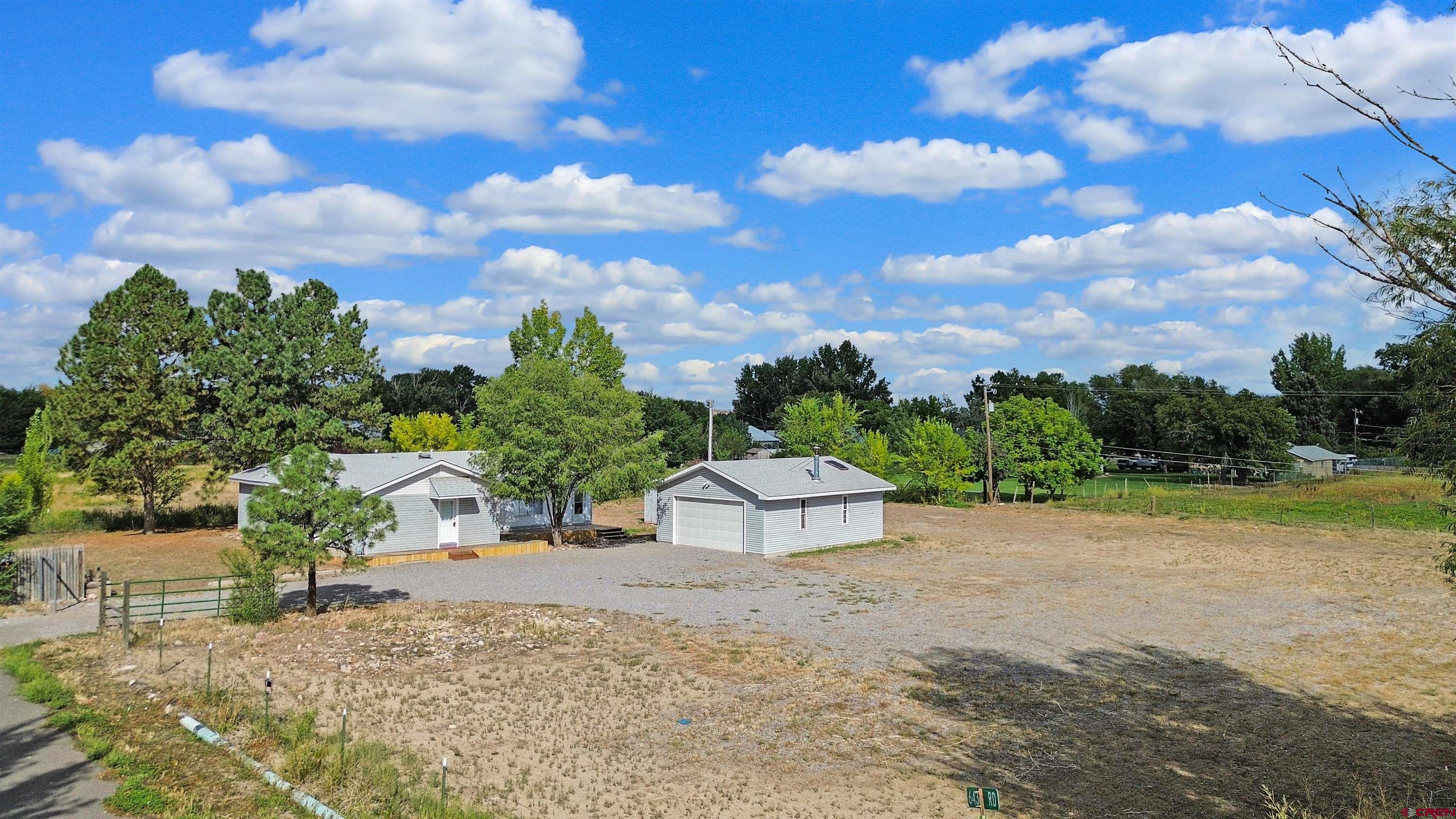 This property offers a rare investment opportunity with eligibility for a major or minor subdivision development, creating strong potential for future development or resale. For those looking to enjoy it now, bring your horses and experience Colorado country living on 2 acres in Montrose. The 1,812 square foot home includes 1.9 shares of UVWUA irrigation water, and the land is fully fenced and ready for horses and animals. There is ample space for livestock, gardening, or simply enjoying the wide open setting on the large 2 acre lot. Inside, a brand new HVAC system with a transferable warranty provides comfort and peace of mind. With no HOA or covenants, you have the freedom to use the property your way, including potential for a home-based business. Just minutes from town, this property offers a rare combination of acreage, water rights, flexibility, and long-term upside. Schedule your private showing today.
