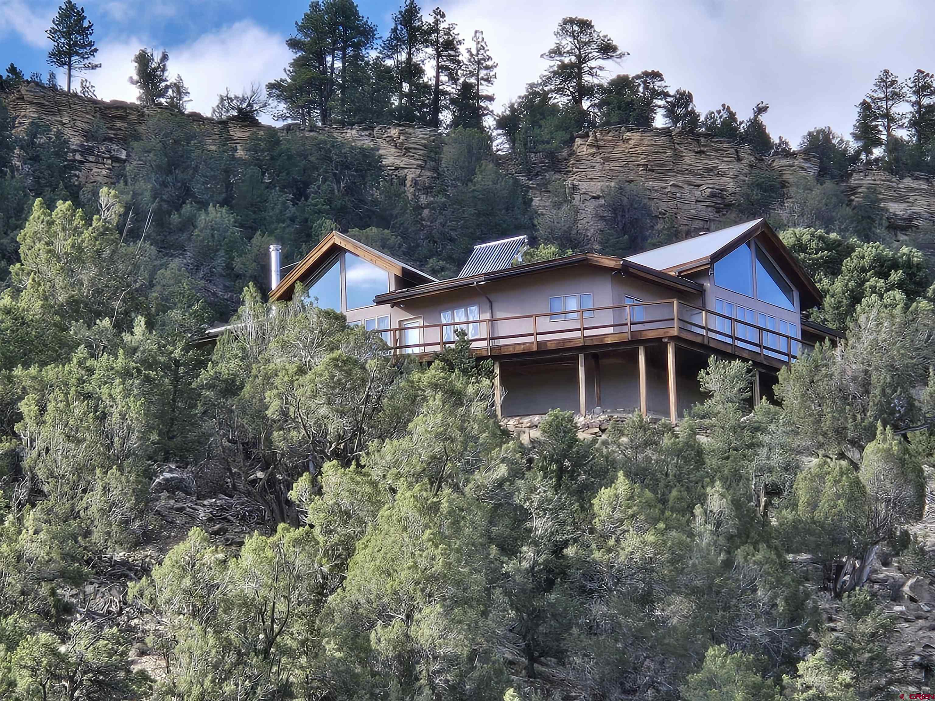 When you think of Colorado and your dream home, it is about the mountain views.   You want a home with the BIG mountain views.   What does that mean?  You want to see Mt Sneffels framed by your living room windows.  You want to see all of the San Juans and all of the Cimarron Mountains.   You want to see Chimney Peak and the Courthouse turn yellow, orange, pink, lavender with the evening Alpenglow.   This Pleasant Valley home with 3 bedroom, 2 baths, and is located on 39 very private acres.  No HOA and no covenants.  Paved access.    Enjoy this special setting, and its proximity to Ouray, Telluride, Montrose, the Cimmarron and San Juan Mountains.  It is a location close to where you want to go.  10 mins to the Town of Ridgway, 40 minutes to Telluride, less than an hour to the Montrose Airport.    Hike, bike, walk, run right from your front door.