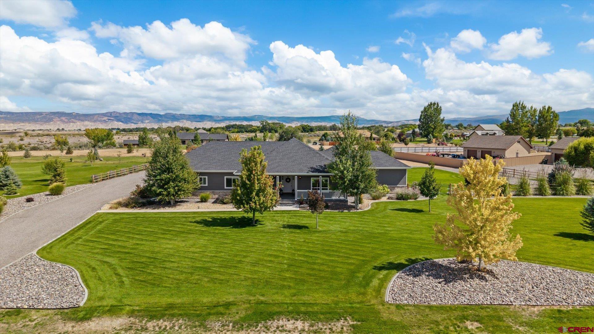 Exquisite 4 Bedroom, 3 Bath Home on 2.02 Irrigated Acres in Spring Creek Meadows!      Welcome to refined country living in one of Montrose’s most prestigious rural subdivisions. This 4-bedroom, 3-bath custom home sits on 2.02 irrigated acres and offers the perfect blend of elegance, comfort, and functionality. Step inside and be greeted by an inviting open floor plan featuring hand-textured walls, custom cabinetry, granite countertops, and stainless steel appliances. Large windows bathe the home in natural light, while the spacious great room with a gas fireplace creates a warm gathering space. The thoughtful split-bedroom layout includes a designated 4th bedroom/office, ideal for remote work or flexible use.    The luxurious primary suite boasts a spa-like bath with an insulated soaker tub, tiled shower, dual sinks, and an oversized closet. Every detail has been carefully designed for both beauty and practicality—including a well-appointed laundry room with a utility sink and folding counter.     Outdoors, the sellers have transformed the backyard into a private oasis—fully fenced, meticulously landscaped, and ready for relaxing evenings or entertaining guests. Irrigation water, included through the HOA, keeps the grounds lush and green. A spacious 3-car attached garage provides ample storage for vehicles, tools, or toys and there is still room on the east side to build a detached shop if that is what is desired.     This home is the perfect balance of rural serenity and upscale living—turn-key, elegant, and move-in ready. Don’t miss your opportunity to own this exceptional property in sought-after Spring Creek Meadows.