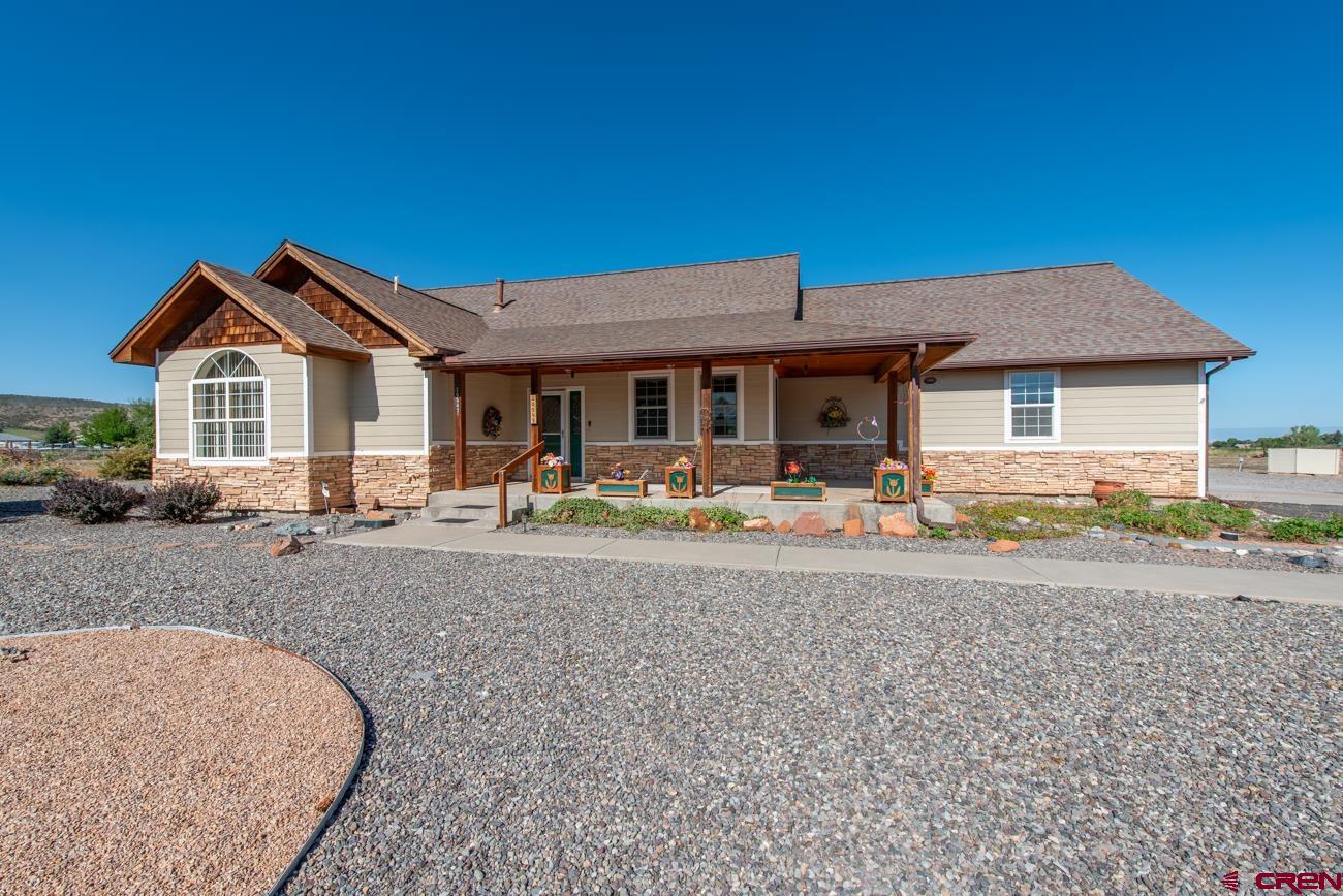 A rare opportunity to own this one-owner, custom-built home on a generous 1.2± acre lot with HOA-supplied irrigation water. Designed with both comfort and function in mind, this single-level layout offers a formal dining room, a highly functional kitchen, and a welcoming living room with a cozy gas fireplace. Solid-surface flooring runs throughout for easy care and timeless appeal.  French doors lead to an enclosed back porch, creating the perfect space to relax or entertain year-round. Enjoy quiet mornings on the inviting covered front porch or gather with friends in the expansive, private backyard. Low-maintenance xeriscaping allows you to spend more time enjoying your surroundings and less time on upkeep.  With ample space to build your dream shop or create the outdoor retreat you’ve always wanted, this property combines practicality with endless possibilities. There is river access to residents.