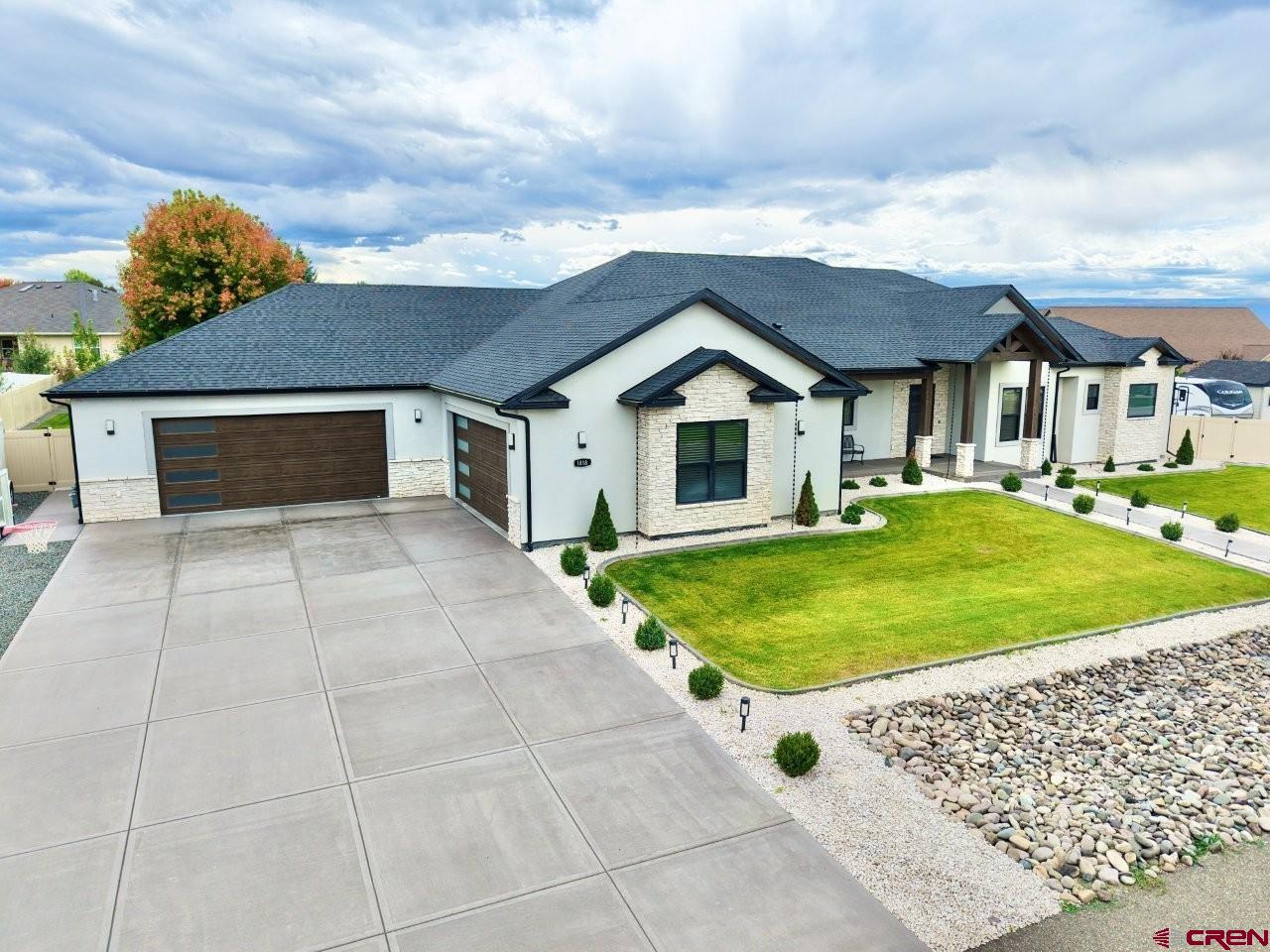 Spectacular custom one-level open floor plan home located in Hill Street Estates with irrigation water. This home features 4 bedrooms and 4 bathrooms and a 1,672 square foot 4-car heated garage that is wired for an electric vehicle, wash sink and has additional storage with ladder access.  This impressive home features a beautiful kitchen with quartz countertops, farm style porcelain sink, white oak cabinets, ZLINE appliances, large pantry and wet bar. The kitchen opens to the main living area that includes a vaulted ceiling and gas fireplace. The master suite features a tile shower with heated floor, stand-alone jacuzzi tub, double vanity vessel sinks, his/her walk-in closets, plus an additional sitting room off the bedroom with access to the covered patio. Two guest bedrooms offer their own private bathrooms and walk in closets. The fourth bedroom is currently being used as an office. The game/movie room offers additional space to enjoy with family and friends. The spacious laundry room includes a wash sink plus an abundance of cabinetry for storage. The exterior has an abundance of features that include a 41’x 16’ covered back patio with T&G ceiling, ceiling fan, and gas stub. The front covered entry features stained timber beams inviting you as you walk to the beautiful Mahogany front door.  The large lot offers a storage shed with power and plenty of additional parking plus RV parking with water, power and sewer hook-up.  The feature list on this home goes on and on. This home will check all the boxes for your client looking for that special home.