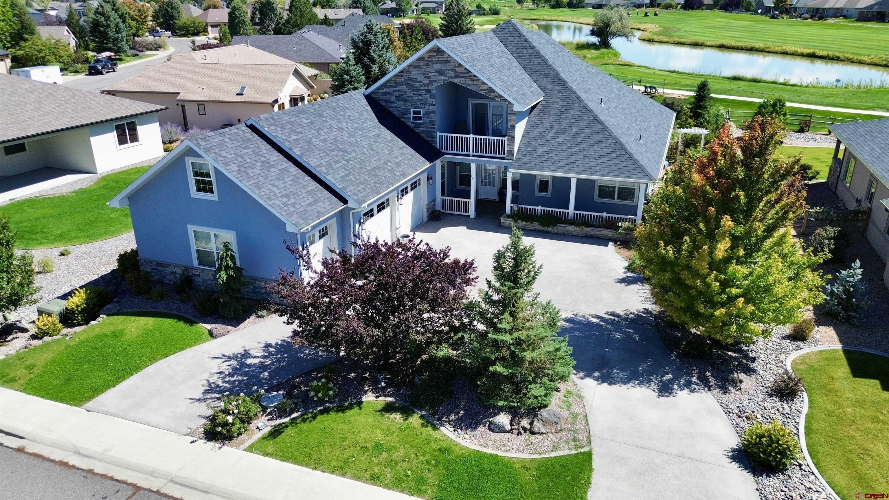 Experience the finest in luxury living and timeless craftsmanship with this extraordinary custom home perfectly positioned on the golf course in Cobble Creek. From the moment you step inside, every detail speaks of elegance and quality. Graceful archways frame the gourmet kitchen designed for both style and function. An expansive island, striking designer lighting, stainless steel appliances—including a gas range top, wall oven, microwave, refrigerator, and wine fridge—make it a chef’s dream. A casual dining bar, walk-in pantry, and additional hall cabinetry add convenience and storage in abundance. A stone accent wall leads you to the impressive great room with dual ceiling fans and a warm gas fireplace beneath a custom mantel. A formal dining area with wainscoting and adjacent built-in display cabinetry provides a perfect space for entertaining in style. The spacious main-level primary suite is a private retreat with a spa-like bath featuring separate vanities, a jetted tub, oversized tiled shower, private toilet, a large walk-in closet plus additional closets. The split floor plan includes two additional bedrooms and a full bath on the main level, along with a powder room for guests. A thoughtfully designed laundry room includes cabinetry and a utility sink. Upstairs, a large family room with deck access captures panoramic views of the course, pond, and the majestic Colorado mountains beyond. A west-facing balcony offers additional outdoor living, while a finished flex/storage room adds functionality. French doors off the living room open to a patio and a beautifully landscaped, fenced backyard complete with raised garden beds and a full sprinkler system. The three-car garage offers an additional utility sink and plenty of space for vehicles and gear. Modern comforts include forced-air gas heat, central air conditioning, and a central vacuum system. This stunning Cobble Creek residence is more than a home—it’s a lifestyle of luxury, comfort, and Colorado beauty.