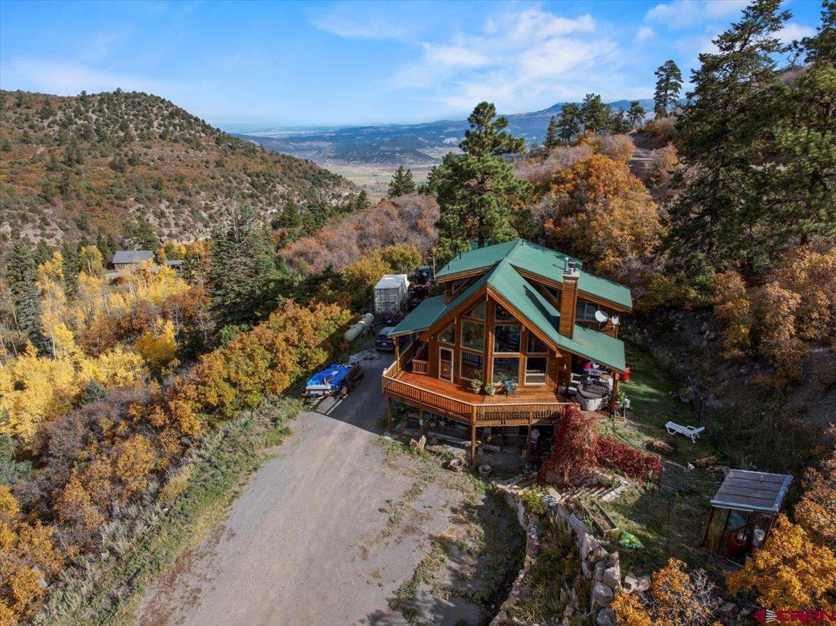 Welcome to a mountain retreat where timeless design meets the untamed beauty of Colorado’s high country. This residence is framed by towering pines and majestic Mt. Sneffels views, offering a rare blend of privacy, comfort, and connection to nature. By day, the home opens to sweeping views of forests, streams, and open skies, as well as private access to the National Forest from the subdivision. By evening, warm light spills across inviting outdoor spaces, creating the perfect setting for gathering or quiet reflection. Thoughtful landscaping adds seasonal color, while nearby water and trails extend the living experience far beyond the walls. Gated access to this mountain property allows for a sense of security. An insulated workshop rounds out the list of benefits. Every detail of the property speaks to a lifestyle defined by serenity, adventure, and an enduring sense of place. More than a home, it is a sanctuary crafted for those who seek both refinement and the restorative power of the natural world.