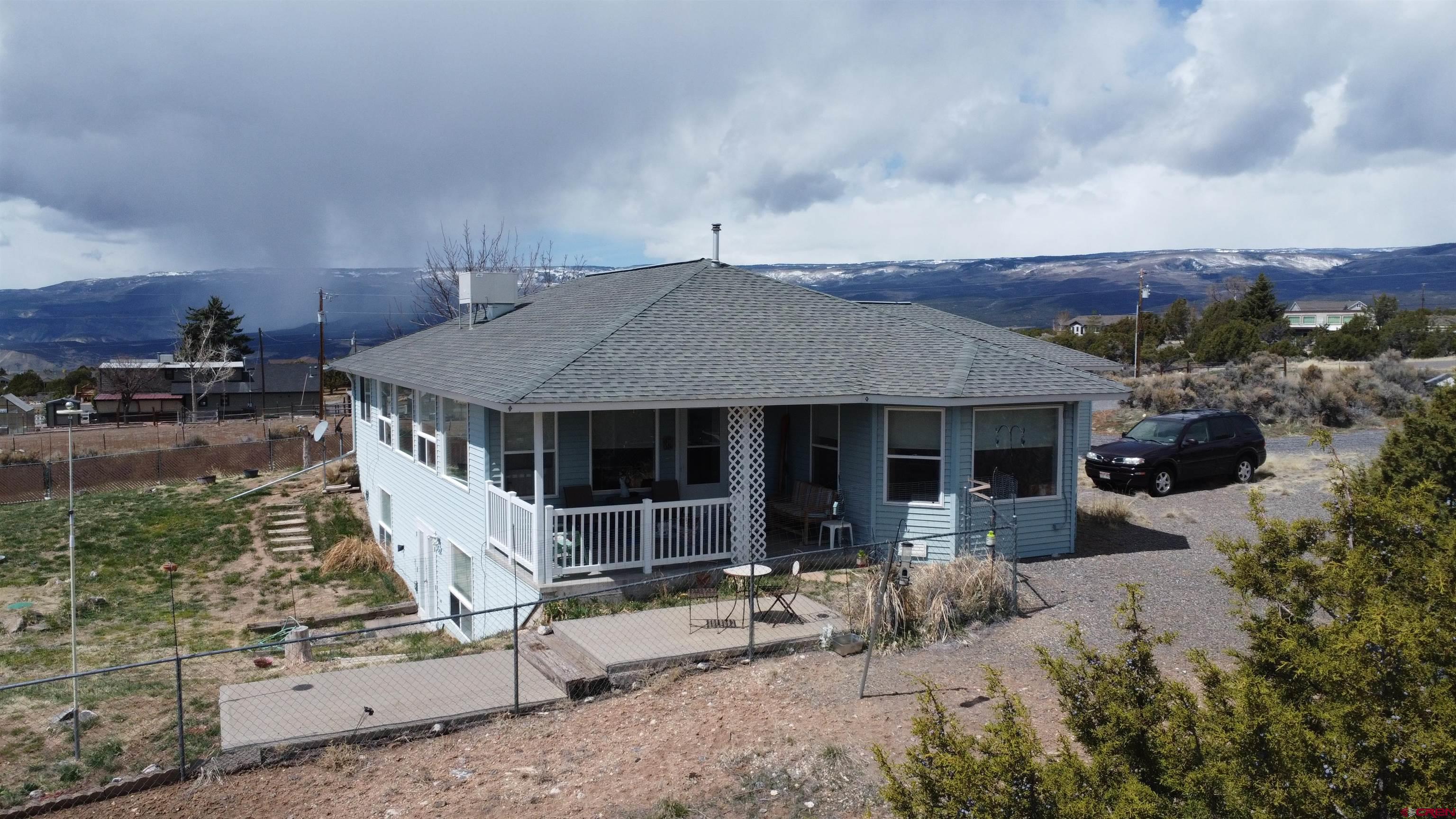 Views, Setting, 3 car garage, AND Energy Efficient!  What more can you ask for in today’s market?  This beautiful 2663 sq ft home has so much to offer.  This home was built by Les Radcliff with quality in every detail.  The home is built using a passive solar envelope that creates a warm and inviting atmosphere.  With a floorplan that allows for the primary suite, laundry room, kitchen, living room, and office/bedroom on the main level this is what everyone is looking for.  One the walk-out basement you have two more bedrooms, a spacious family room, and bathroom.  This property offers amazing views and is placed on the 2.13 acre corner lot to allow elbow room from your neighbors.  With a fenced-in yard you will allow your pets or children to play outside without worry and it even has a garden shed for more storage.  The floorplan is amazing with an open concept kitchen/living room to the split bedroom design this home is just what the doctor ordered.  The three car attached, garage offers enough space for toys and vehicles and this home even boasts a central vacuum system!  Look closely as you won’t find much you won’t like about this property.  It is simply stunning.