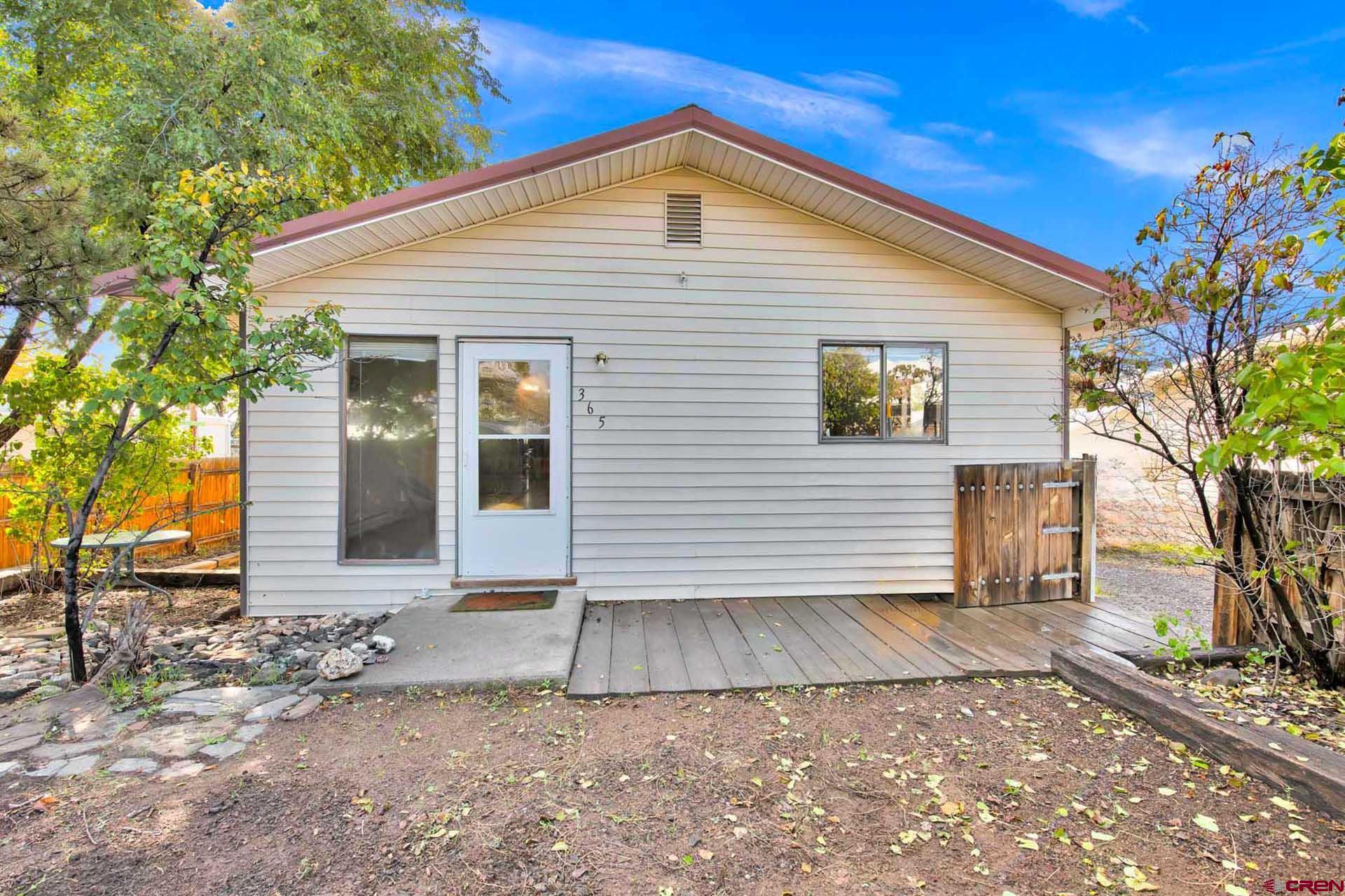 Charming home and property in Cedaredge close to the elementary school and down town amenities. 3 bed, 2 bath 1312 sq. ft. with a big fenced back yard area and detached garage/studio. This home has low maintenance with a metal roof and vinyl siding. Separate tastefully finished garage/studio gives you additional options. Other great features that really compliment the back yard area are a gazebo set on pavers and a nice fire pit area. This lot provides good privacy with your own little backyard oasis. High end water heater and Brand new refrigerator. Spot for a wood or pellet stove. All of this for under 300K!