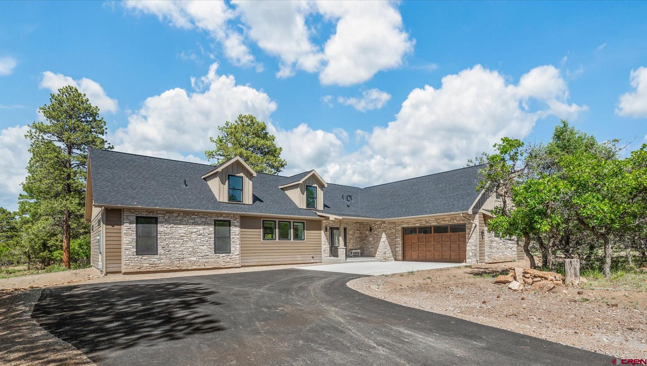 Brand New and Elevated Mountain Luxury Home On 1 Acre Bordering Golf Course with Fabulous Finishes! Every detail in this home has been dialed to perfection from beginning to end. Sharp curb appeal is heightened by dormer windows, a side entry garage, and a beautiful, Colorado-inspired stone and LP smartlap siding combination, which is also framed by towering pine trees creating a gorgeous and private alpine experience. Step inside to contemporary custom craftsmanship like you've never seen, accented by brilliant natural light streaming through all angles of this inspiring masterpiece. Gaze through the inviting, open-concept floor plan through 10' sliding glass doors featuring an enchanting Colorado forest backdrop. Epitomize the art of entertaining with multiple living and dining areas, complimented by an additional bar and sink in the oversized dining room. The main event could be the exquisite chef's kitchen, boasting a 55 cubic commercial-style stainless fridge, a 40 sq. ft island with top-notch quartz countertops, and a shocking amount of counter space. It doesn't stop there with an oversized farm sink, 2 independently mounted wall ovens, a huge oven, and large pantry! The main en-suite is something out of a dream with a massive walk-in shower with beautiful tile, and a large walk-in closet. This space also delivers uncompromising views and extra space, which could be utilized as the perfect spot for your morning yoga routine. Your loved ones will enjoy their own slice of indulgence in the guest suite, which is well-equipped with a tiled walk-in shower and closet, all located in a well-designed floor plan for privacy. As you head upstairs you will find that this custom home keeps on delivering fabulous feature after feature with an incredible game/family room space, 2 additional bedrooms, another full bathroom, and a hidden bonus room which could be the perfect home office or workout space. In what can only be described as the ultimate outdoor base camp, you will find unmatched recreation opportunities in every direction. Spend your summers on a jaw-dropping golf course with breathtaking views of the San Juans, and your winters snowshoeing and cross-country skiing. Enjoy additional year-round activities such as world-renowned mountain biking and gold medal fishing, all with the convenience of world-class healthcare and airport service in nearby Montrose. A Serene Dream of Elevated Mountain Euphoria is Waiting; What Are You Waiting For?