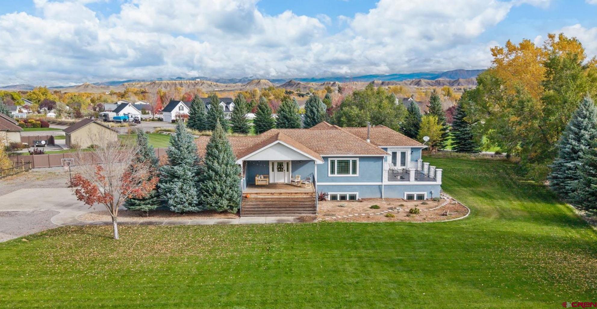 Dreams Come True in This Fantastic 5-Bedroom, Sprawling Estate Home on Over an Acre with Irrigation Water and RV Parking in River's Edge! Imagine an idyllic, peaceful neighborhood, surrounded by gorgeous and mature landscaping, 1+ acre lots with privacy and versatility abounding, with private access to the Uncompahgre River around the corner? Need extra room to accommodate extra loved ones living with you, but don't want to spend multiple millions to get all of this in Western Colorado? Look no further. Primary en-suite on the main level, 4 additional bedrooms with split floor plan privacy, a huge, walk-out basement, a massive kitchen/living/dining set up to accommodate all of your entertaining pursuits. The kitchen delivers a large island, an ergonomic layout, an eat-in bar, a large pantry, and tons of counter space. The main en-suite provides a large walk-in closet, extra room for a reading nook or home gym setup, a beautiful, tiled walk-in shower, and private access to the backyard. Convenience and function are accounted for with a spacious laundry room, perfect to keep the mess out of sight. 2 of the guest bedrooms are equipped with jack and jill style bathroom setup, which could be ideal for those needing multi-generational living options. The garage is oversize and would accommodate most larger vehicles with ease, and has extra room for whatever projects and tinkering hobbies you have. With the temperate, superb climate and high-quality of life in Montrose, the only question is whether you will spend more time in your colossal and curated home, or outside in the incredible oasis that is your own, irrigated, lush landscape lined with towering pine trees and 2 expanded patios. A large driveway enables easy RV parking and room for additional vehicles. Inside and Out, This Home is Ready and Waiting to Bring You and Your Clan's Kingdom to Life in Spectacular and Enriching Ways; Experience It For Yourself Today!