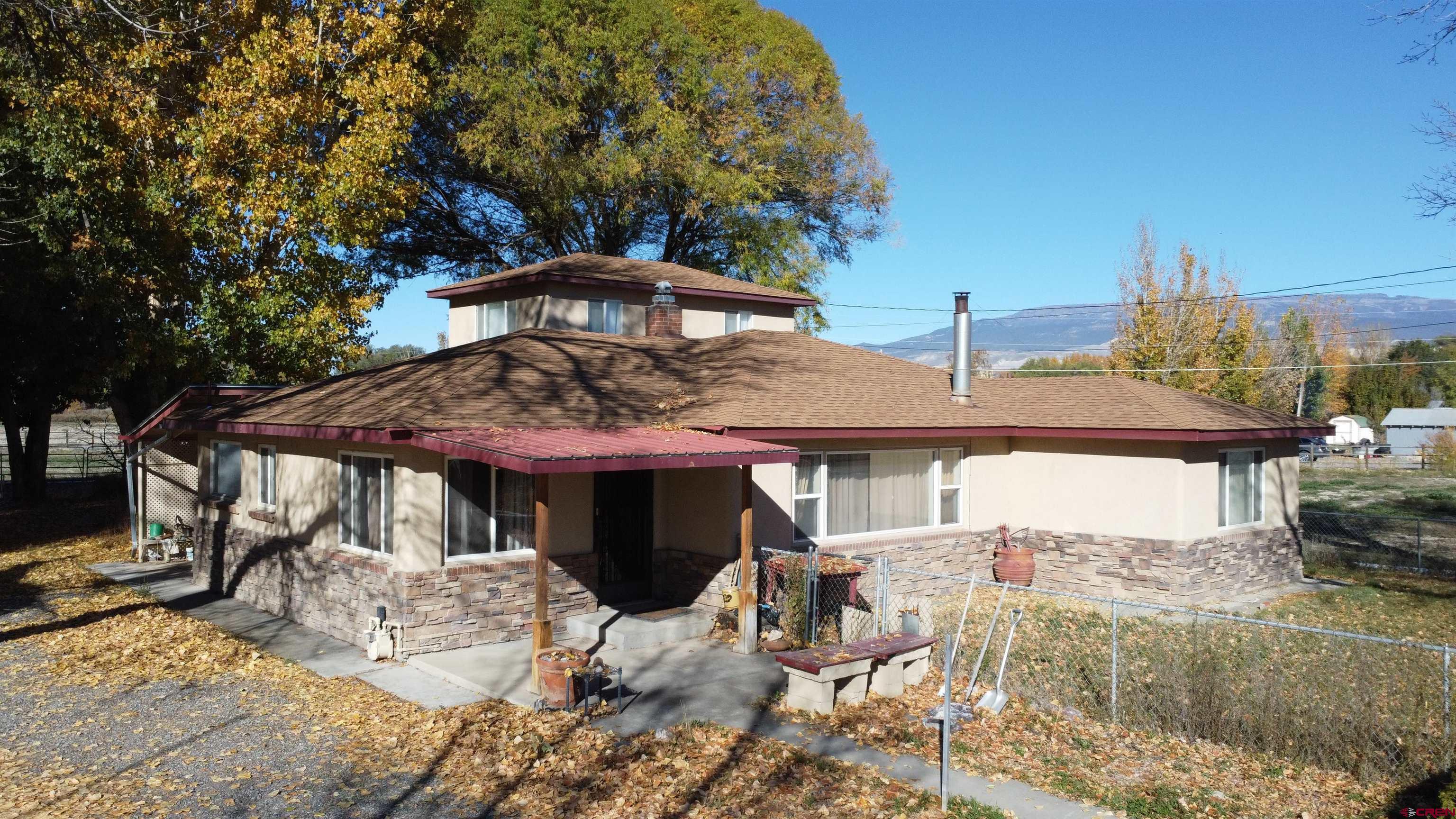 Welcome to this charming country property located just minutes from downtown Delta, CO. Situated on a spacious 2.08-acre lot, this home offers 1,888 square feet of comfortable living space featuring 3 bedrooms and 1.75 bathrooms. Enjoy peace of mind with a brand new roof installed in May 2025.  The fenced yard is perfect for your dogs and horses, providing plenty of room to roam. For hobbyists and outdoor enthusiasts, there is a large 30x42 shop and two carports, offering ample space for your play toys and equipment. The property also includes pasture land with irrigation water, ideal for gardening or raising animals.  Inside, a newer furnace and central air system ensure year-round comfort. The kitchen features many windows that allow natural light. This home combines the tranquility of country living with convenient access to the amenities of Delta. Don't miss the endless possibilities this property has to offer!