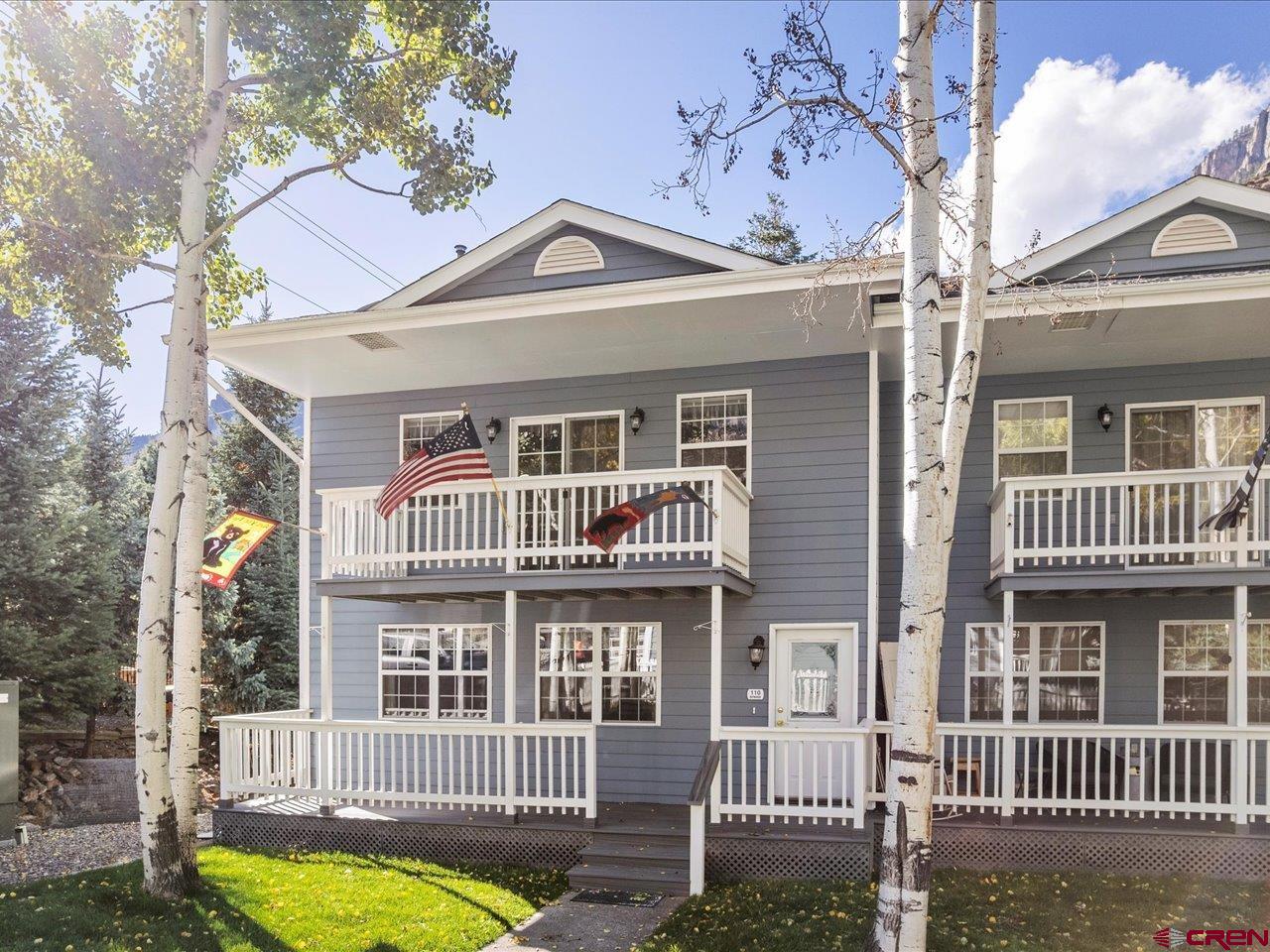 Riverfront Townhome with Stunning Views in Ouray, Colorado This lovingly maintained, all-original townhome sits right on the Uncompahgre River and offers spectacular views of the Amphitheater, Mt. Abrams, Hayden Mountain and Twin Peaks cliffs. Featuring two bedrooms, 2.5 baths, a spacious kitchen, large laundry room, and a cozy pellet stove, this home combines mountain charm with everyday comfort. Enjoy outdoor living on four decks, two facing east and two facing west.  The west side includes a large, landscaped lawn right on the banks of the Uncompahgre River.  Plus the convenience of a 750 square foot two-car attached garage, with extra room for toys such as ATVs or motorcycles.  There is plenty of additional parking for guests and family. Located just two blocks off Main Street, you can walk to everything in town—restaurants, shops, and Ouray’s famous hot springs pool. This is an owner-occupied complex with a minimum rental lease of one full year, ensuring a quiet, well-cared-for community. Perfect as a full-time home or a long-term mountain retreat, this townhome captures the best of life in the outdoor capital of Colorado.
