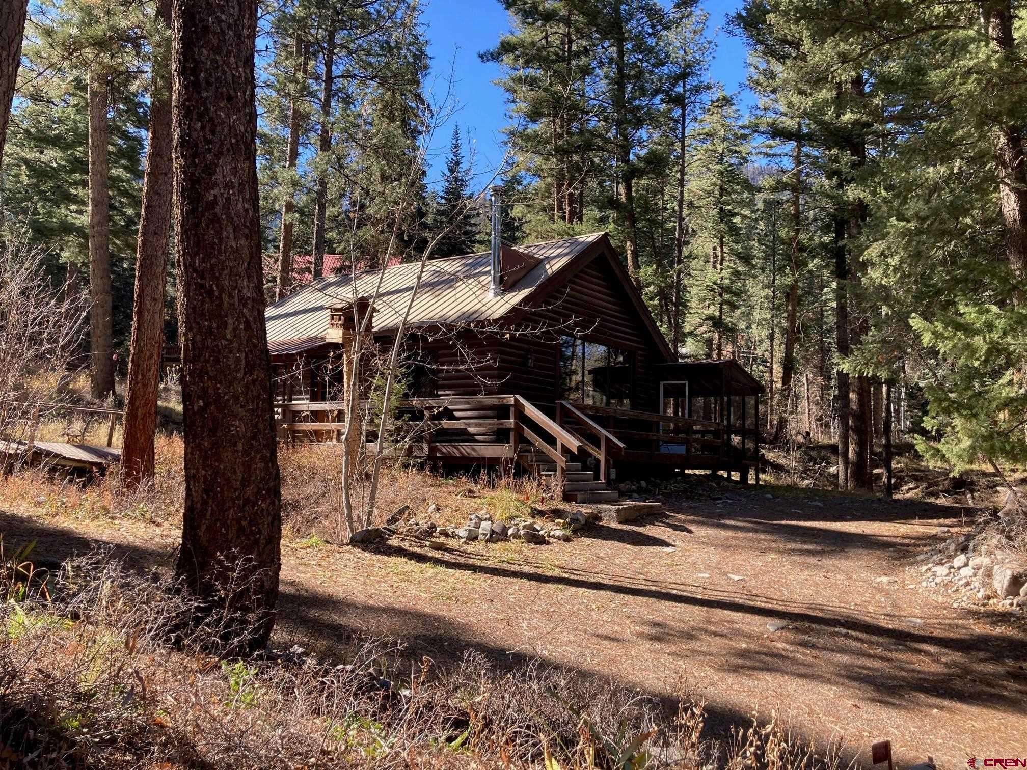 Discover an incredible opportunity to own a classic mountain cabin just north of Ouray, Colorado! Priced to sell, this cabin sits on a spacious 1/2-acre lot and is conveniently located just over the Whispering Pines Bridge. Enjoy easy access to Ouray, or head up the highway toward Ridgway and Telluride. For outdoor enthusiasts, the Dallas Trail is nearby, offering fantastic hiking experiences throughout the region! This cabin is a blank canvas, following a full clean-up with carpets, cabinets, and appliances removed, allowing you to envision its true potential. As a true log cabin, it features a classic layout with a large living area and kitchen downstairs, complemented by stunning vaulted ceilings and expansive windows that showcase breathtaking views. The main floor includes a cozy bedroom, a full bath, and a staircase leading to a loft that overlooks the great room. Step outside to enjoy the lovely screened-in porch on the north side, along with generously sized decks on the front and south sides. Heating is provided by electric baseboards and a charming wood stove, while natural gas has been previously connected but currently has no meter. High-speed internet is also available. A spacious two-car garage is located near the home, with ample parking areas and no HOA restrictions. Unique items, including antique car parts and two outhouses, add a quirky charm to this mountain retreat. Please note, this property is not eligible for typical financing due to its current condition. Buyers wishing to use a loan must ensure their lender understands the property’s status for approval. The seller will review all offers on November 14th, with potential offers requiring proof of funds and pre-approvals submitted by Thursday, November 13th, at 5 PM. The seller will not be making any improvements or modifications. This is a rare opportunity for a year-round home, weekend getaway, or investment property. Don’t miss out on this unique mountain cabin near Ouray! ember 14th.  Potential offers must be submitted with proof of funds and pre-approvals by Thursday November 13th at 5 PM.   Seller will not be making any improvements or modifications.  Despite the above this is an opportunity seldom seen, and we hope that you're as excited as we are to make this your year-round home, weekend getaway, or investment property. Don’t miss out on this unique mountain cabin near Ouray!