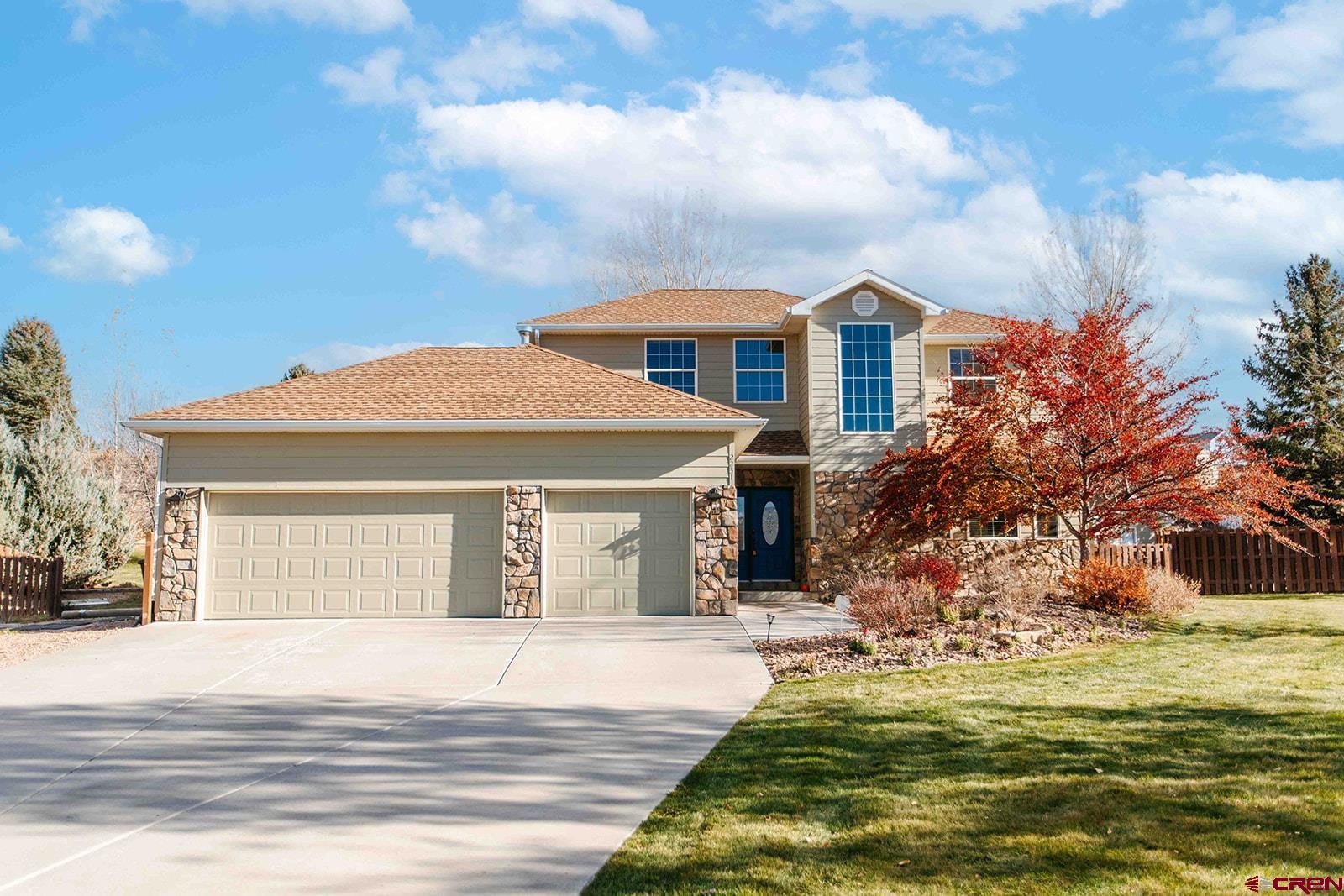 Beautifully maintained and thoughtfully designed, this custom home welcomes you with an inviting foyer and elegant dining room featuring custom maple cabinetry. The spacious living room offers a vaulted ceiling, gas fireplace, large windows, and additional built-ins. The well-appointed kitchen includes maple cabinetry with crown molding, granite countertops, all appliances, pantry with barn door, window over the sink with views, and a casual dining area. The main-level primary suite features a vaulted ceiling, large windows overlooking the backyard, and an ensuite with soaking tub, separate shower, private water closet, and a walk-in closet with built-ins. A dedicated main-level office with more maple built-ins provides ideal workspace. A half bath and spacious laundry room complete ths main level. Upstairs, two roomy bedrooms share a Jack-and-Jill bath. Finishes include maple hardwood in main areas, tile in baths, and nearly-new carpet in living room, bedrooms and office. The finished three-car garage offers upper storage racks, plus room beside the home is in place for an RV or toys. Exterior was recently painted, and the matching shed (drywalled with electricity) adds extra storage. Set on a one-acre lot in the Fox Hill subdivision, the property features mature landscaping, garden beds, producing fruit trees, and a fully fenced backyard. Enjoy Grand Mesa views from the side patio or afternoon shade on the private east-facing patio, already wired for a hot tub. HOA irrigation water included in low annual dues of $300.  Convenient east-side location with quick access to downtown and south commercial amenities. Make this home your next home!