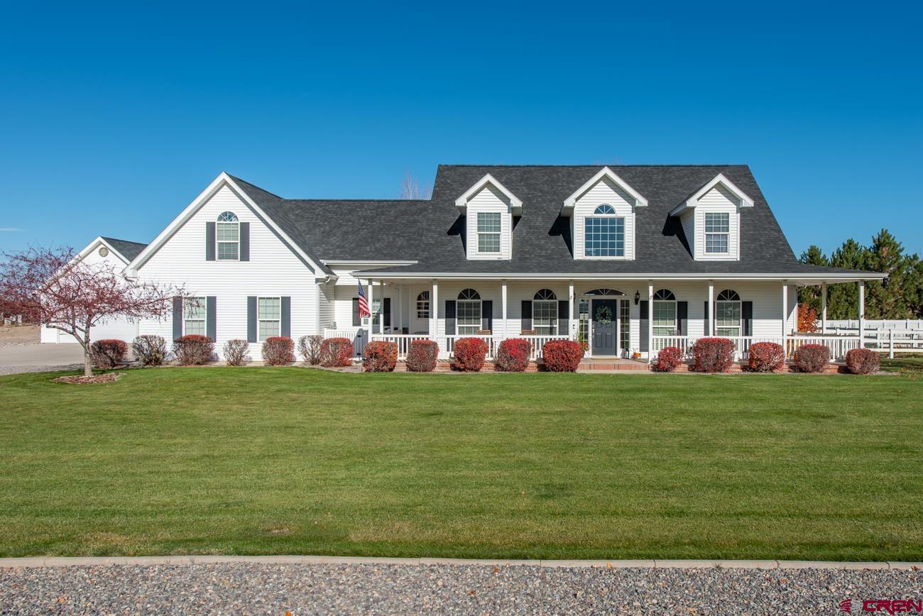 Welcome to this stunning custom home that exudes class and style with its detailed finishes and stature. Nestled in a wonderful neighborhood south of town with exclusive access to the Uncompahgre River - perfect for walking along trails, fishing or just enjoy the peacefulness of the running water. - this well maintained 4-bedroom, 2 full and 2 half bathroom residence blends timeless style with modern comfort. Enter the home from a classic wraparound pillared front porch to be greeted by an elegant entry, wood floors, and a beautiful staircase. The main floor features an inviting layout highlighted by a stunning living room with soaring ceilings, an abundance of natural light from oversized windows, and a cozy gas fireplace. The custom chef-inspired kitchen boasts granite countertops, newer appliances, a pantry, a center island and breakfast bar. There is both a formal dining room and a sunny breakfast nook for casual meals. The primary suite is conveniently located on the main level and includes a luxurious 5-piece ensuite bath with a jetted soaking tub, large walk in tiled shower, dual granite sinks with a vanity desk, and 2 walk in closets. A second bedroom, which could be used as an office, and a half bath complete the main level, along with a well-appointed laundry room featuring counter space and a utility sink. Upstairs, you’ll find two generous bedrooms with ample closet space, a full bathroom, and a cozy landing where you can enjoy the views through the second floor windows. The bonus room above the attached two-car garage offers incredible flexibility, with two additional rooms, a half bath, and mini splits for personalized comfort—perfect for a home office, home gym, studio, or guest suite. Enjoy Colorado’s beautiful seasons from the covered and lighted back patio, complete with a natural gas grill. The large fenced backyard includes a separate gardening area with fruit trees, ideal for those with a green thumb. The property also features an oversized heated 2-car garage/shop, providing plenty of space for hobbies, storage, or additional vehicles. Current owner is having a privacy fence installed just west of this detached garage to store your toys behind for a more eye pleasing and secure setting. This exceptional Montrose home combines classic design, comfort, and functionality in a picturesque setting. This is a stunning one of a kind home!  Due to a family loss, this home is ready to welcome its next owners.