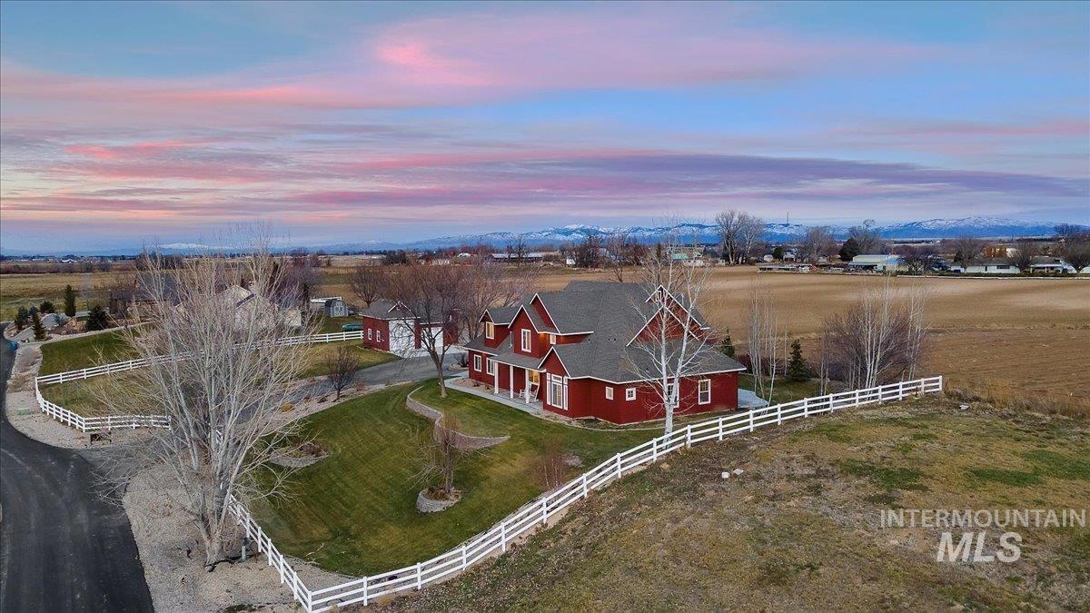 This newly remodeled modern farmhouse is ready for its debut! Freshly painted in crisp beautiful white, updated light fixtures, all new flooring and light pouring in from the sky high windows fulfill this home's luxury potential. The raised elevation allows you to take in the sunrise on the Boise foothills in the morning and sunsets over the Owyhee Mountains in evenings. Enjoy the quiet of a private lane in this small neighborhood of 3 homes and yet have easy quick access to Meridian Rd for all your in town needs. Master is on the main floor, large upstairs bonus room could easily double as a 5th bedroom. The extra large laundry room has a laundry shoot for added convenience. Spend the day in your shop with power and upstairs loft for extra storage (also newly painted) or tend to your four legged friends on it's acreage and then the evenings around your outdoor firepit. It even has a new gravel pad for your camper or other adventure vehicles. Truly a slice of Idaho one only dreams of having. - Nina Palmer, Main: 208-440-6500, Better Homes & Gardens 43North, Main: 208-381-8000, https://www.ninapalmer.com