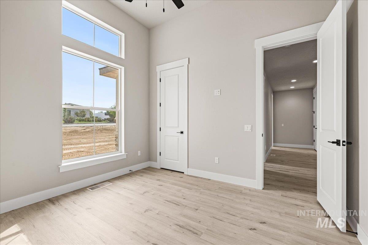 Unfurnished bedroom featuring light wood-style floors and ceiling fan