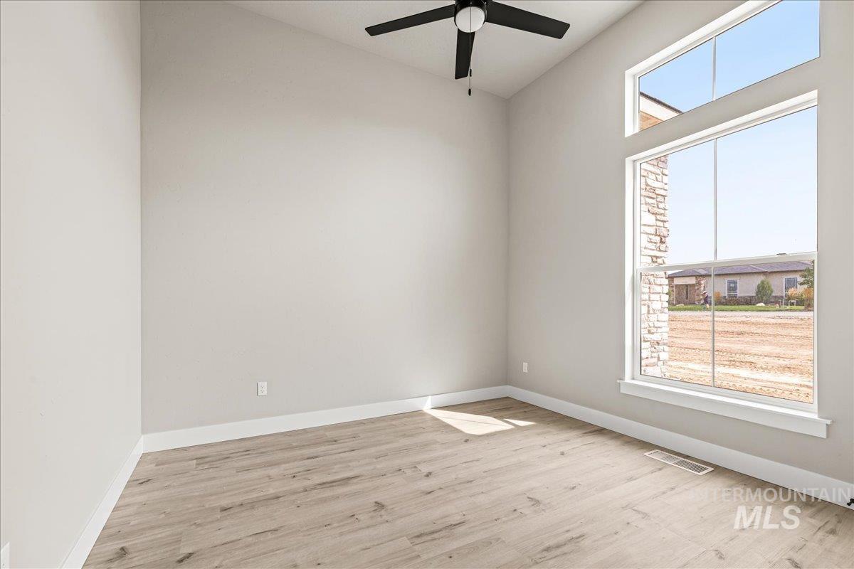 Spare room featuring light wood-type flooring and a ceiling fan