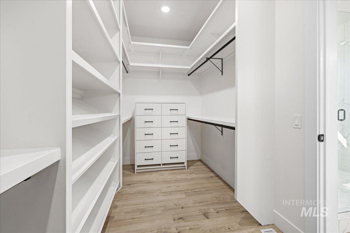 Walk in closet featuring light wood-type flooring