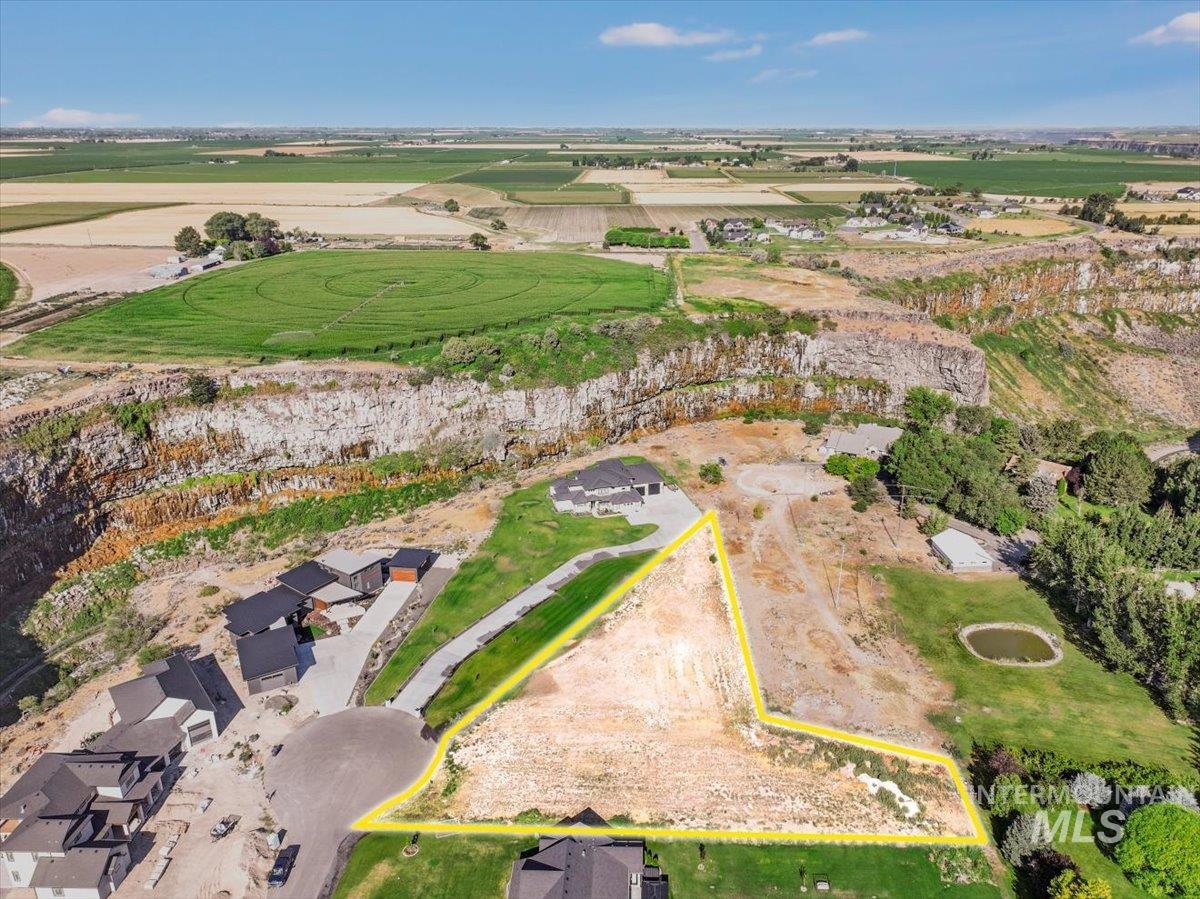 Aerial view of property's location with property parcel outlined and rural landscape