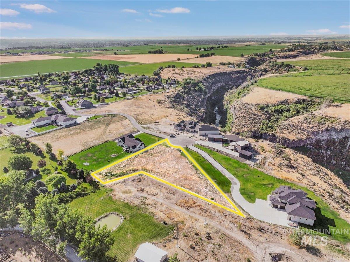 Aerial view of property's location with property parcel outlined and rural landscape